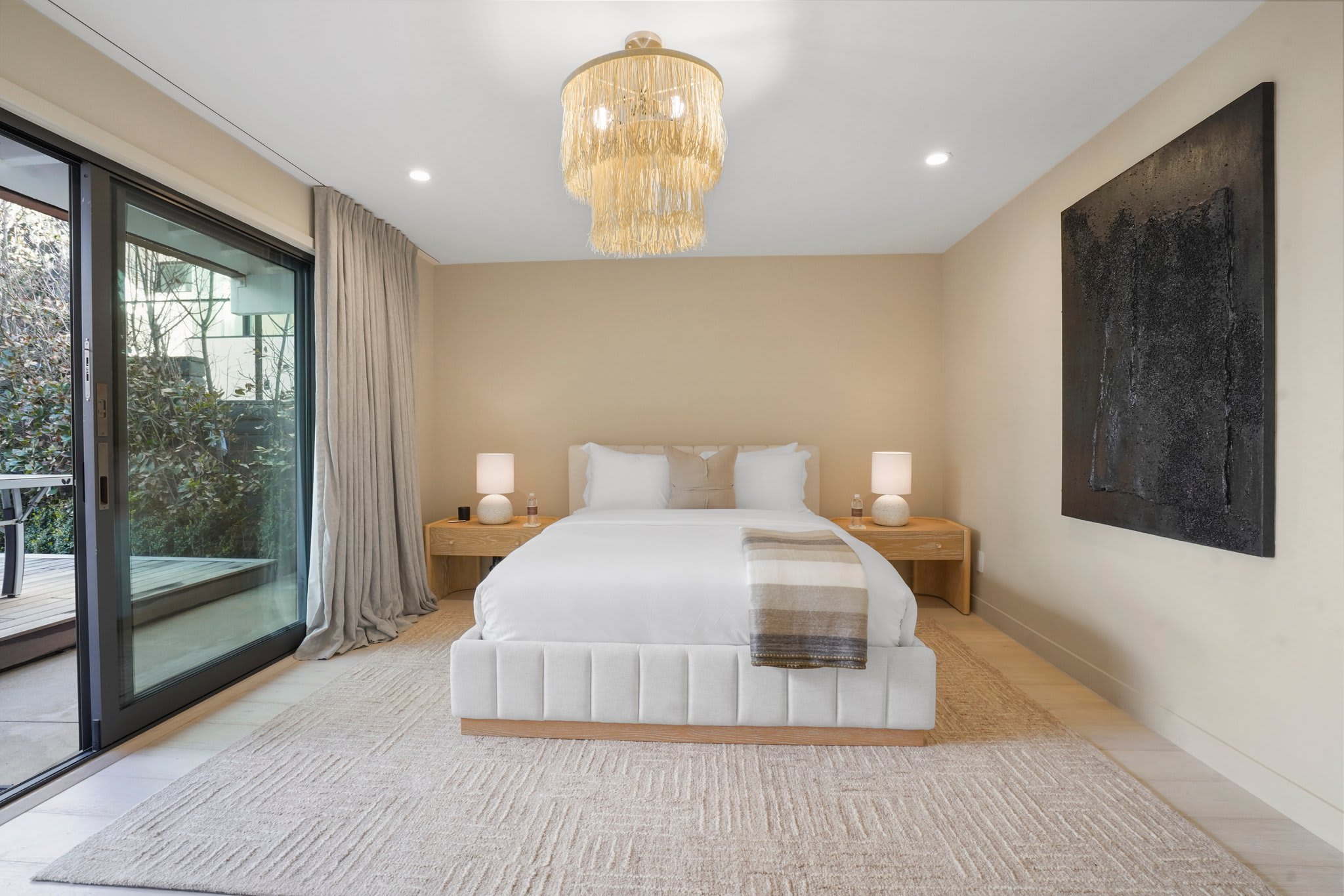 Unwind in a serene retreat, complete with soft textures and warm lighting.