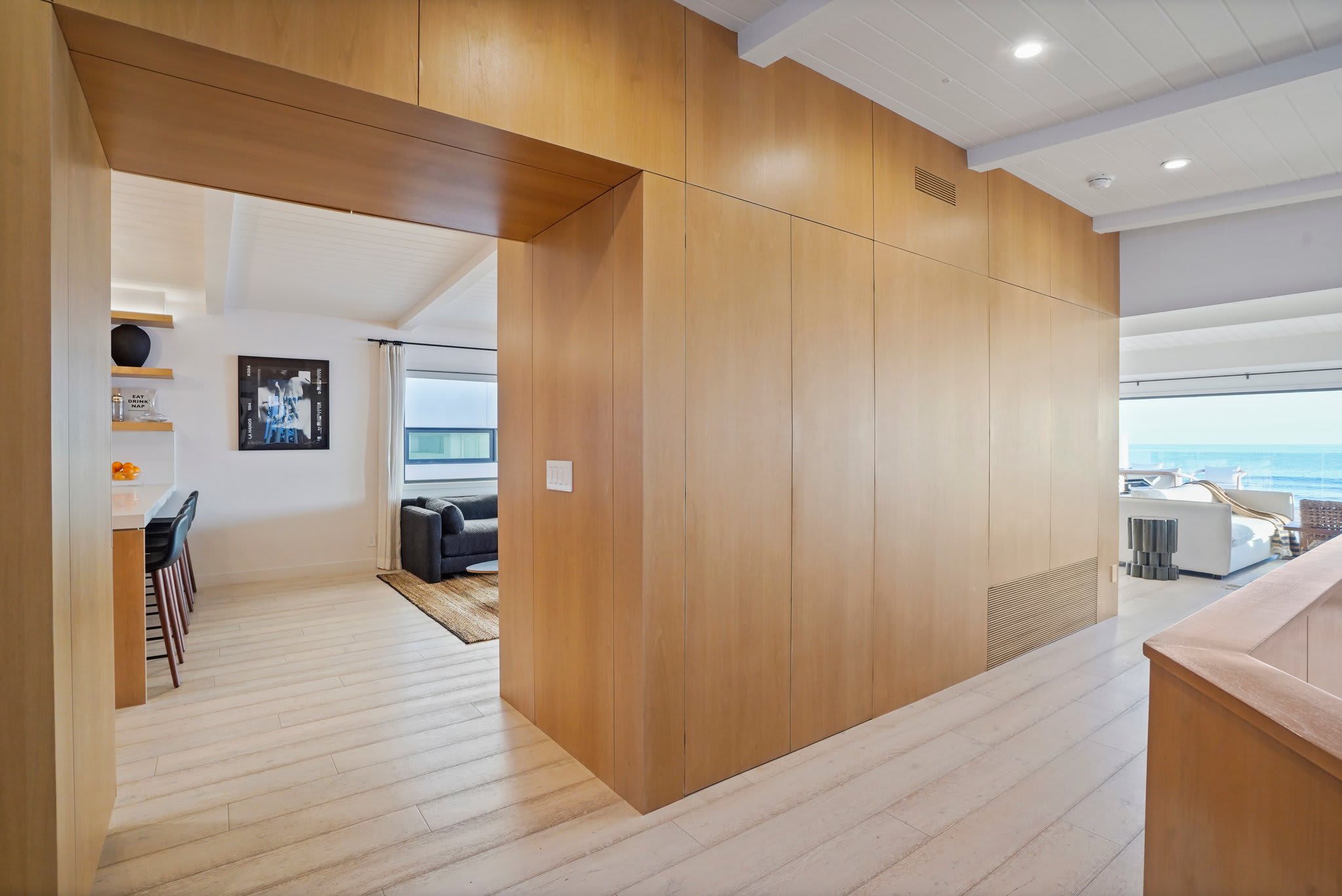 Move through warm wood-paneled interiors that open to endless ocean views