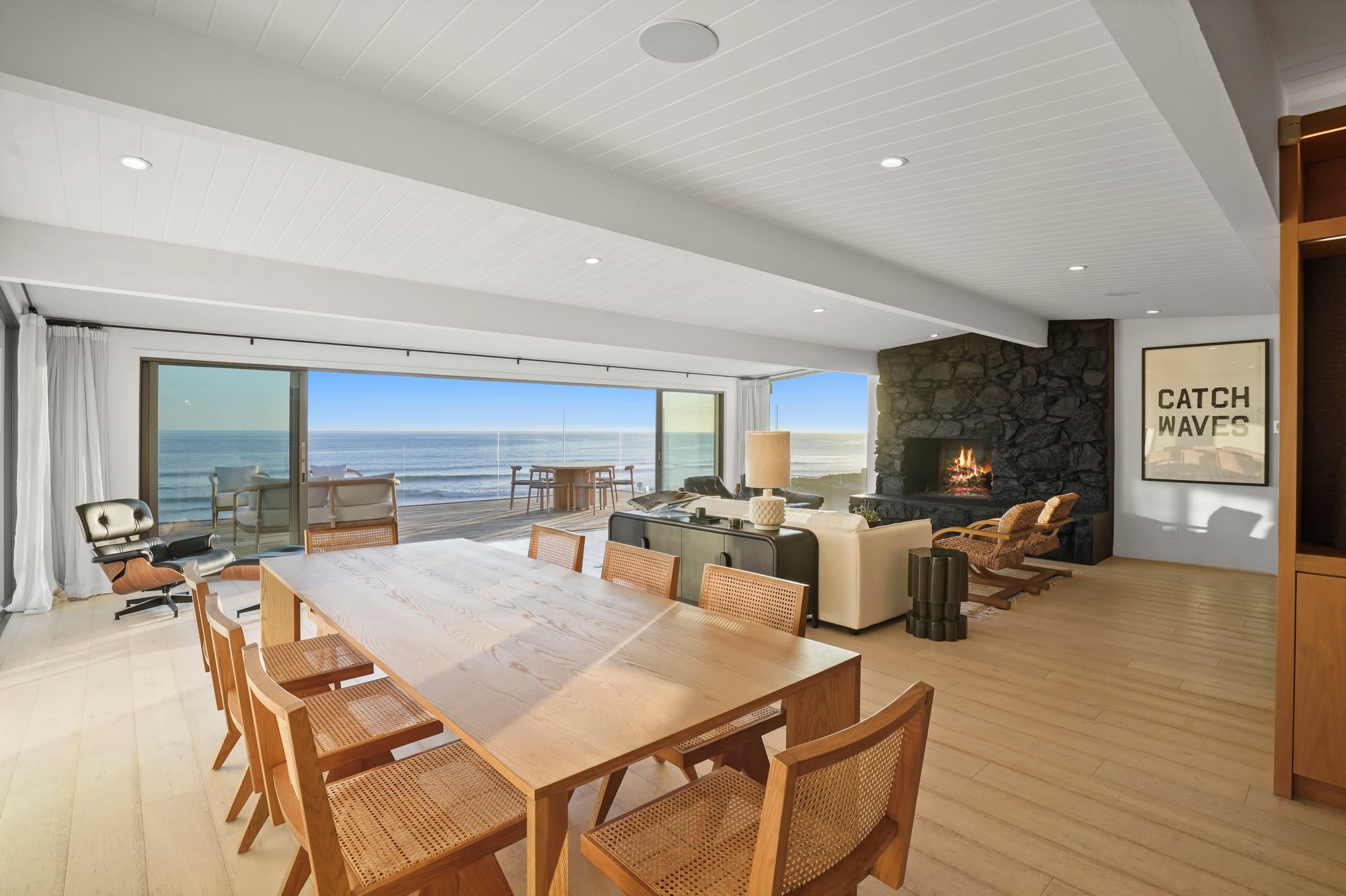 Gather around the solid wood dining table, with the Pacific as your backdrop.