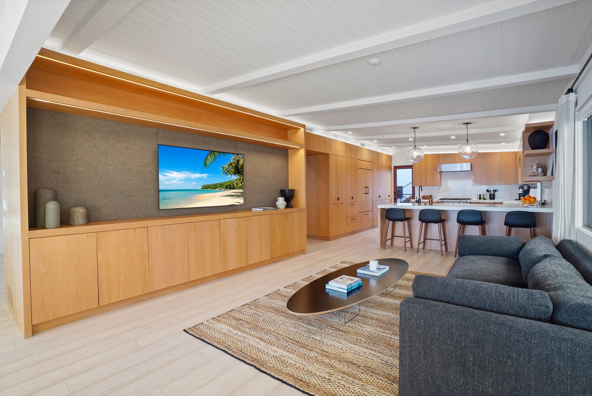 Lounge in style with custom built-ins, plush seating, and seamless flow to the kitchen.