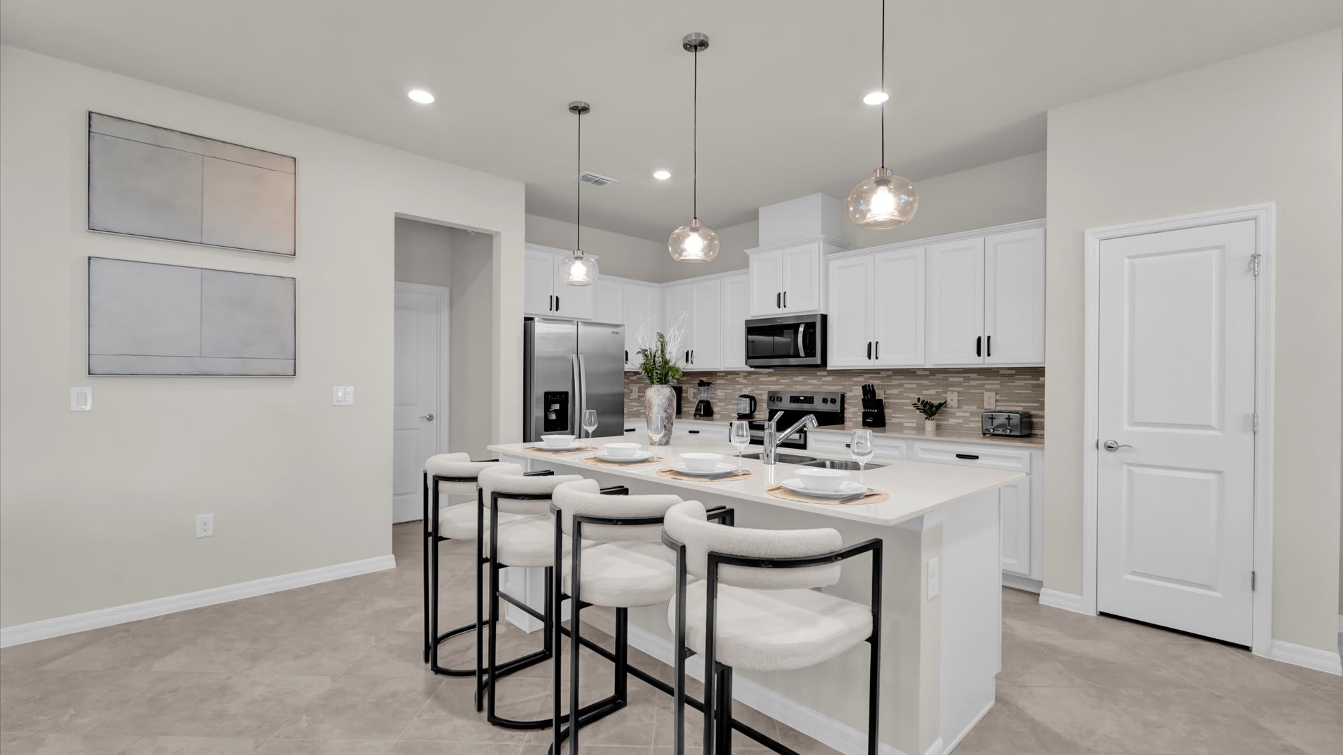 Kitchen with centered island and bar stools