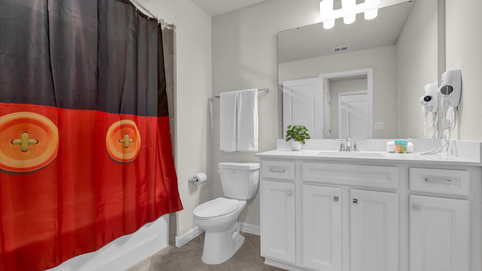 Full bathroom with vanity, shower and hairdryer