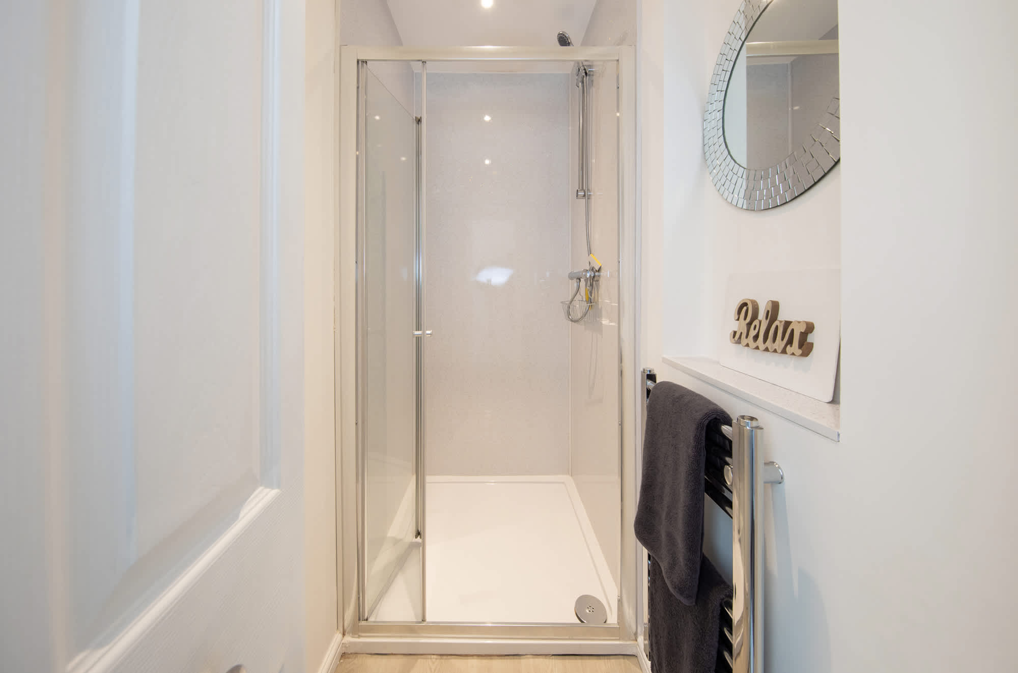 The sparkling shower room with a heated towel rail