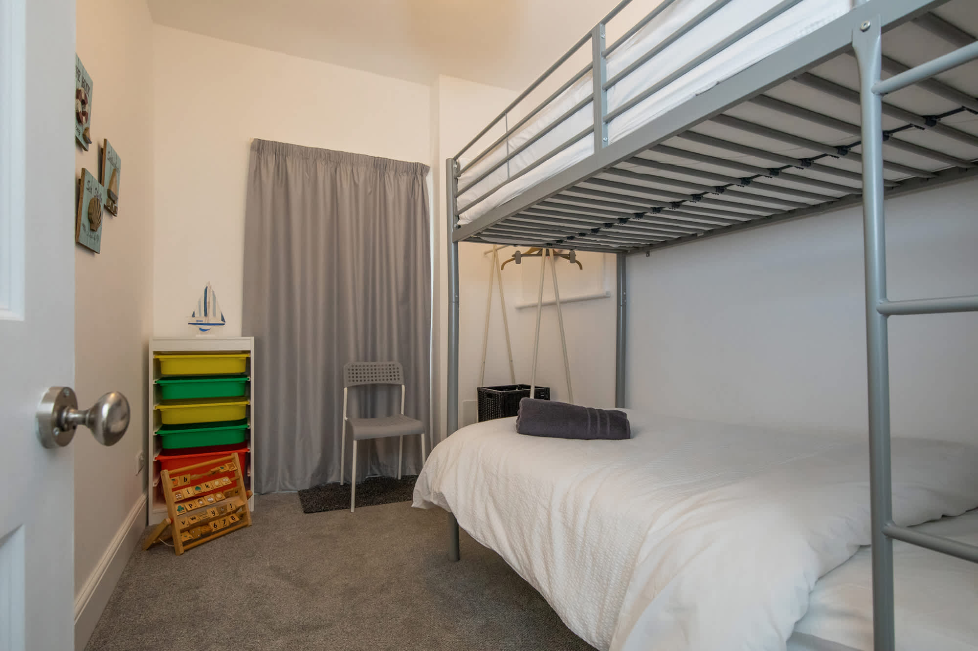 The fun kids room with a bunk bed and games