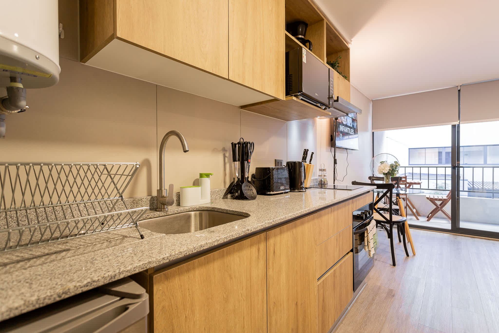 Enjoy cooking in this modern kitchen with sleek appliances and a cozy dining area overlooking the city.