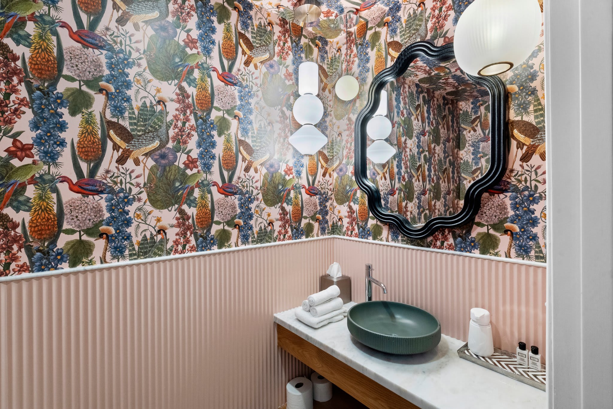 Elegant powder room with modern fixtures and a chic design, perfect for a refreshing touch-up during your stay.
