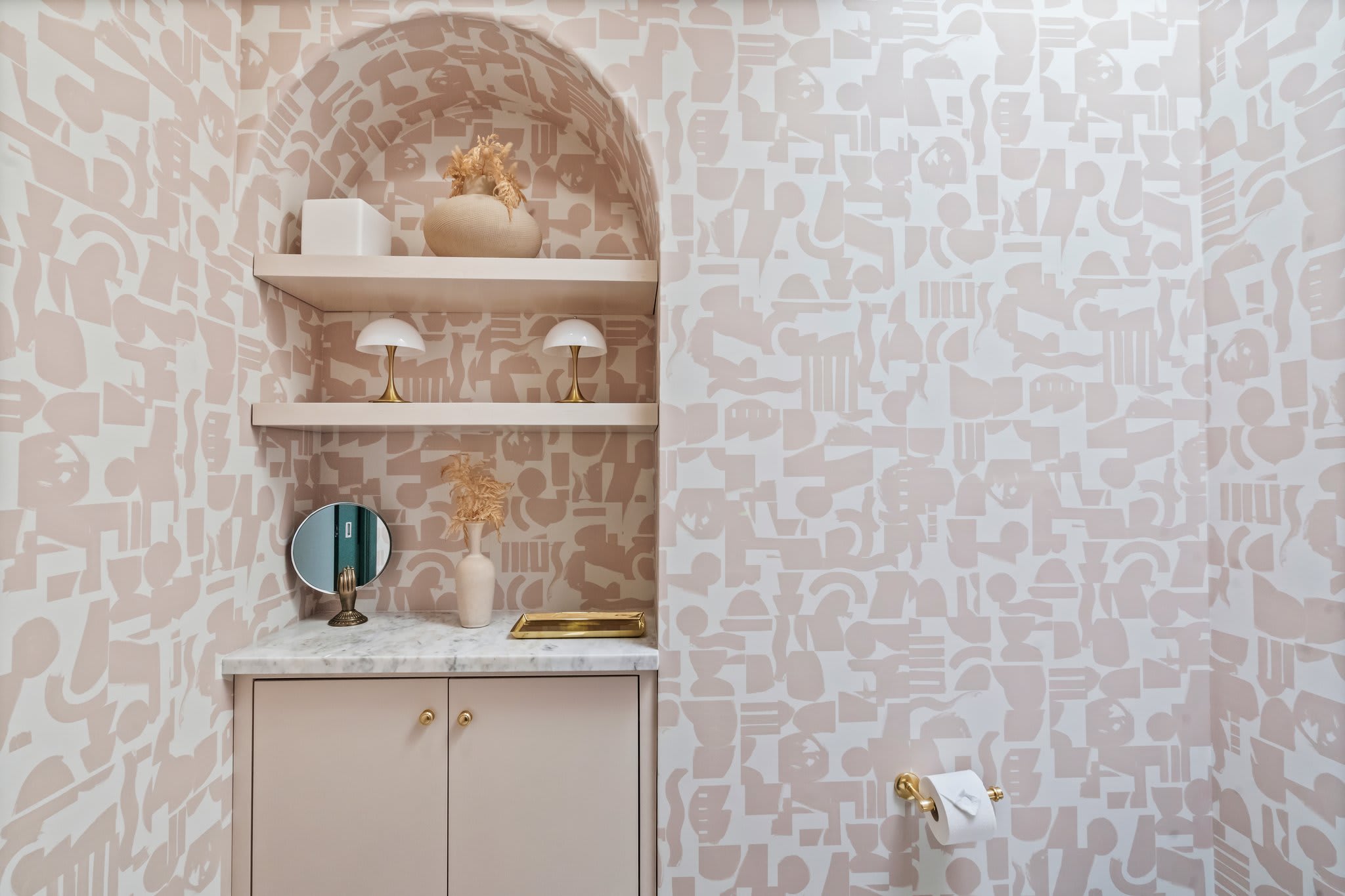 A powder room with personality—soft hues and sculptural accents.