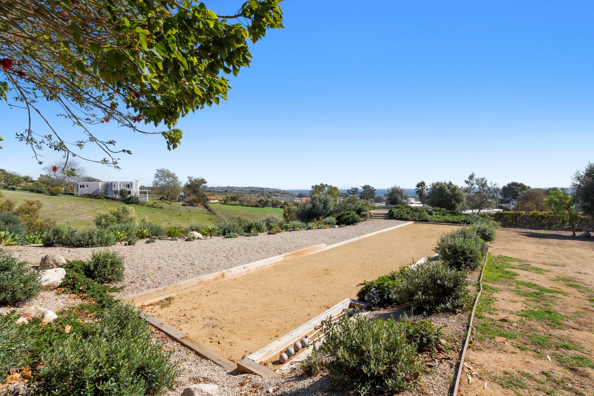 A regulation-sized bocce court with panoramic hillside views.