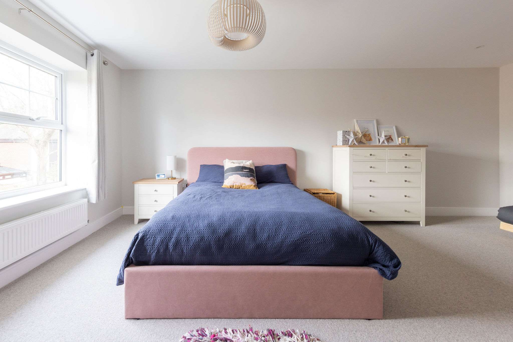 This room is light and airy with large window, check of drawers and bedside table.