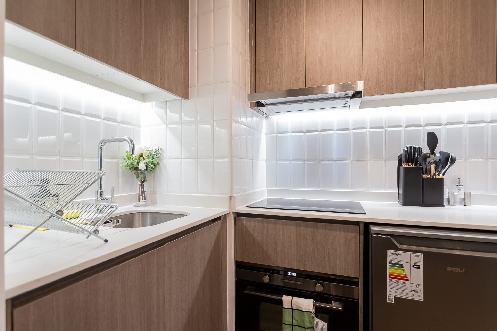 Modern and efficient kitchen with sleek appliances and stylish design, perfect for cozy meals in your Chilean studio retreat.