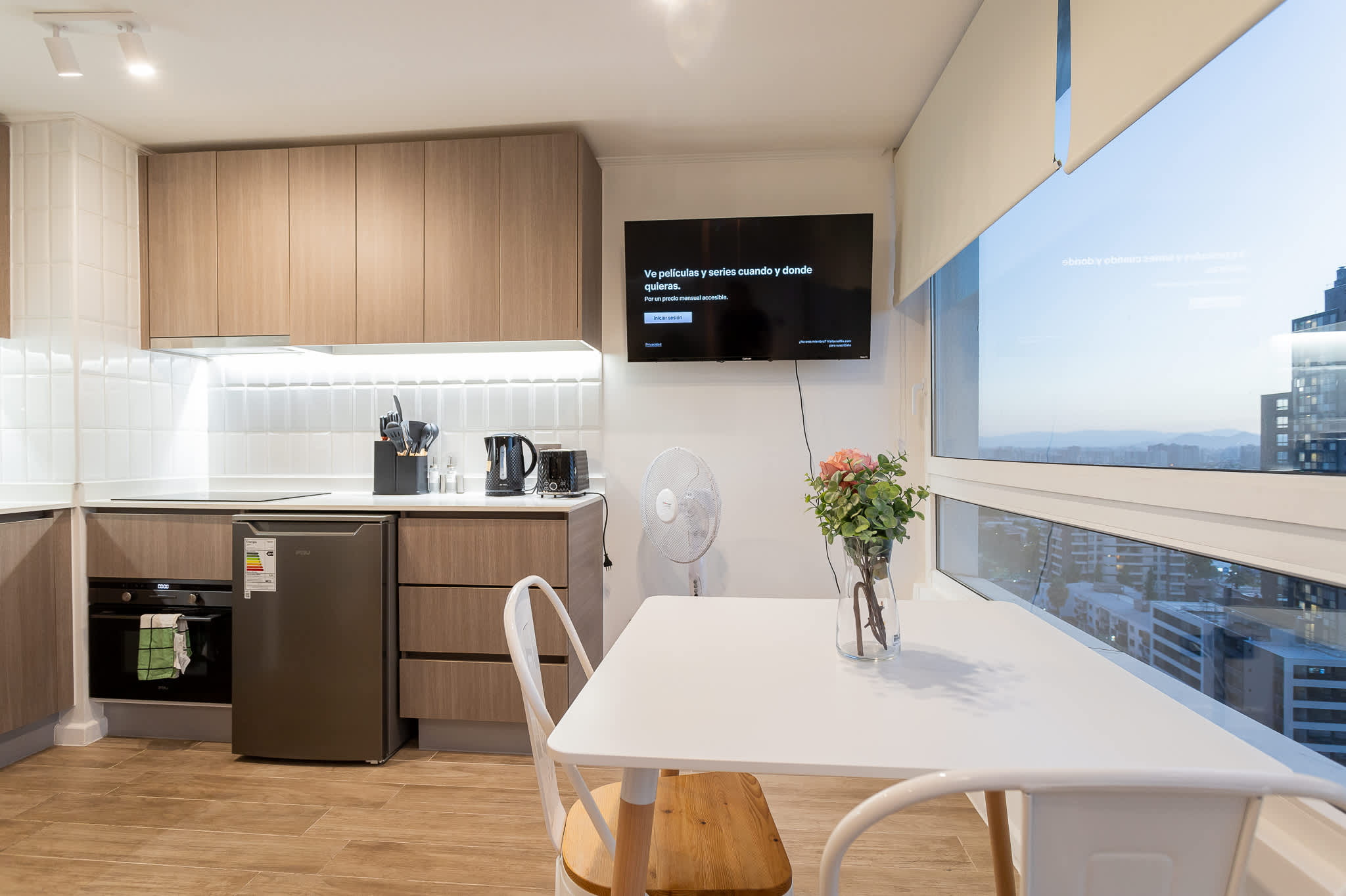 Cozy studio kitchen with modern amenities and stunning city views, perfect for a romantic getaway in the heart of Chile.