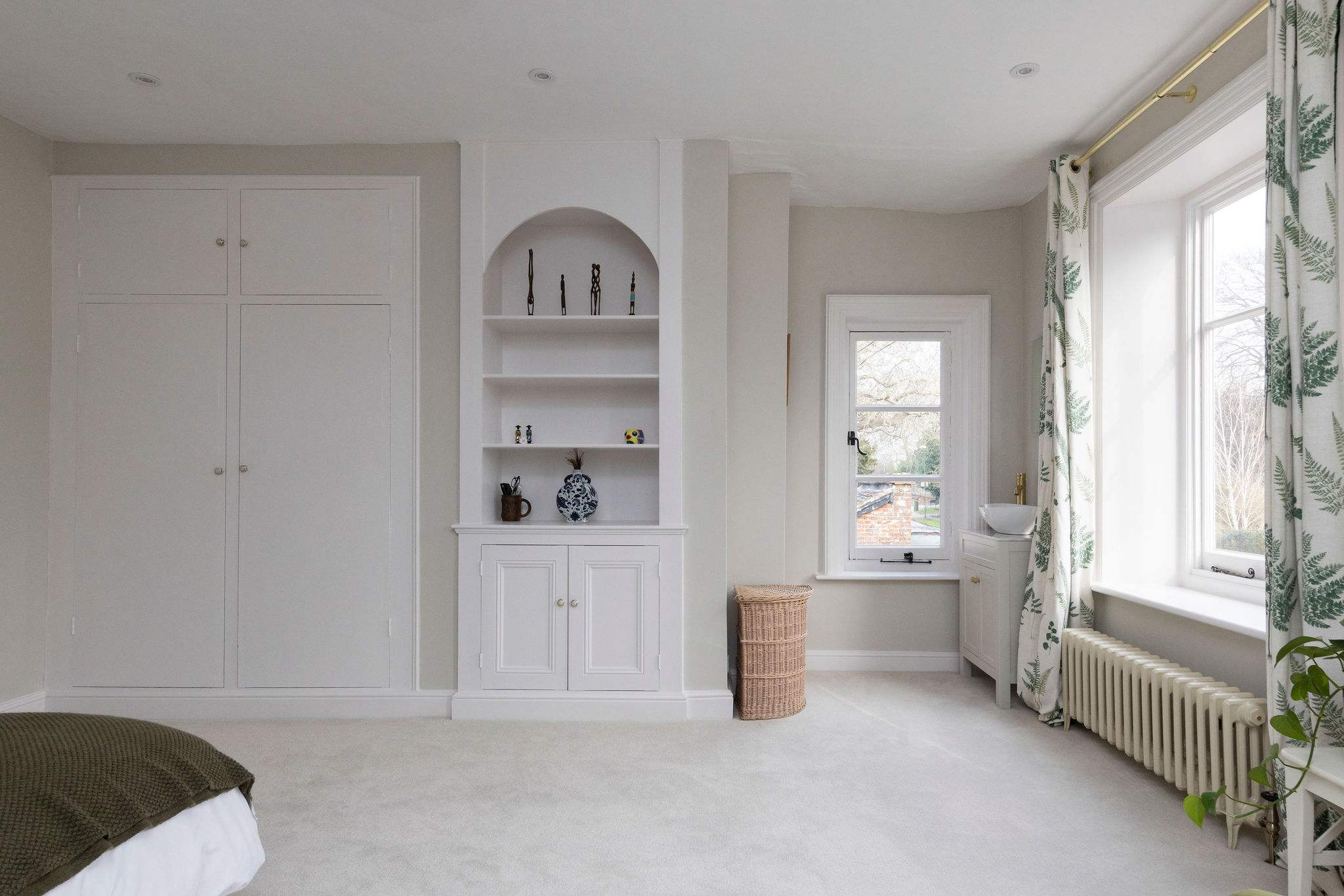 Spacious second bedroom with built-in storage and bright windows