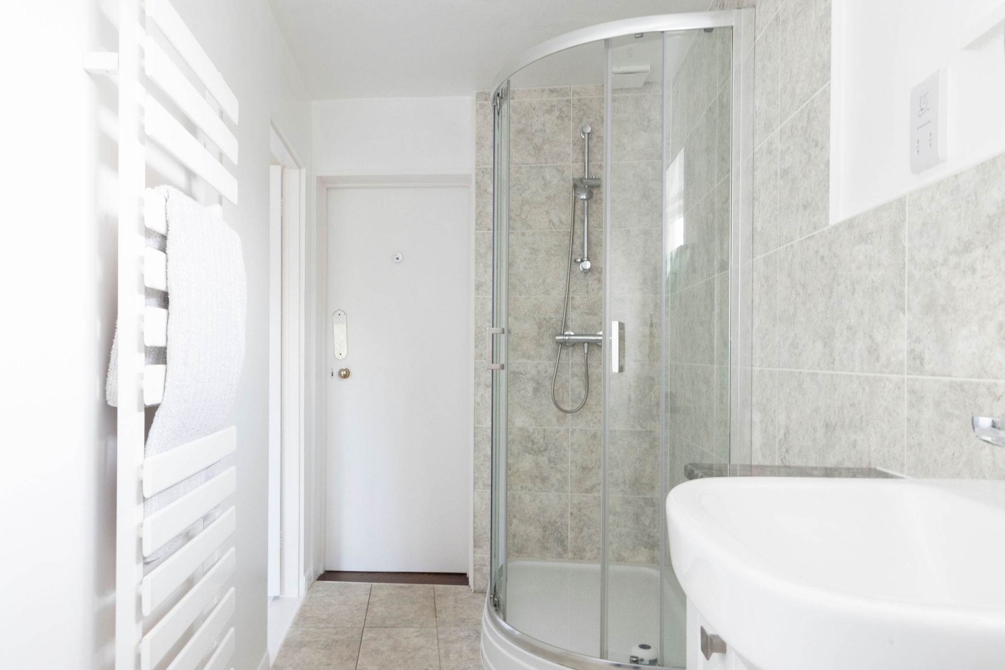 A sleek glass-enclosed shower with a modern touch