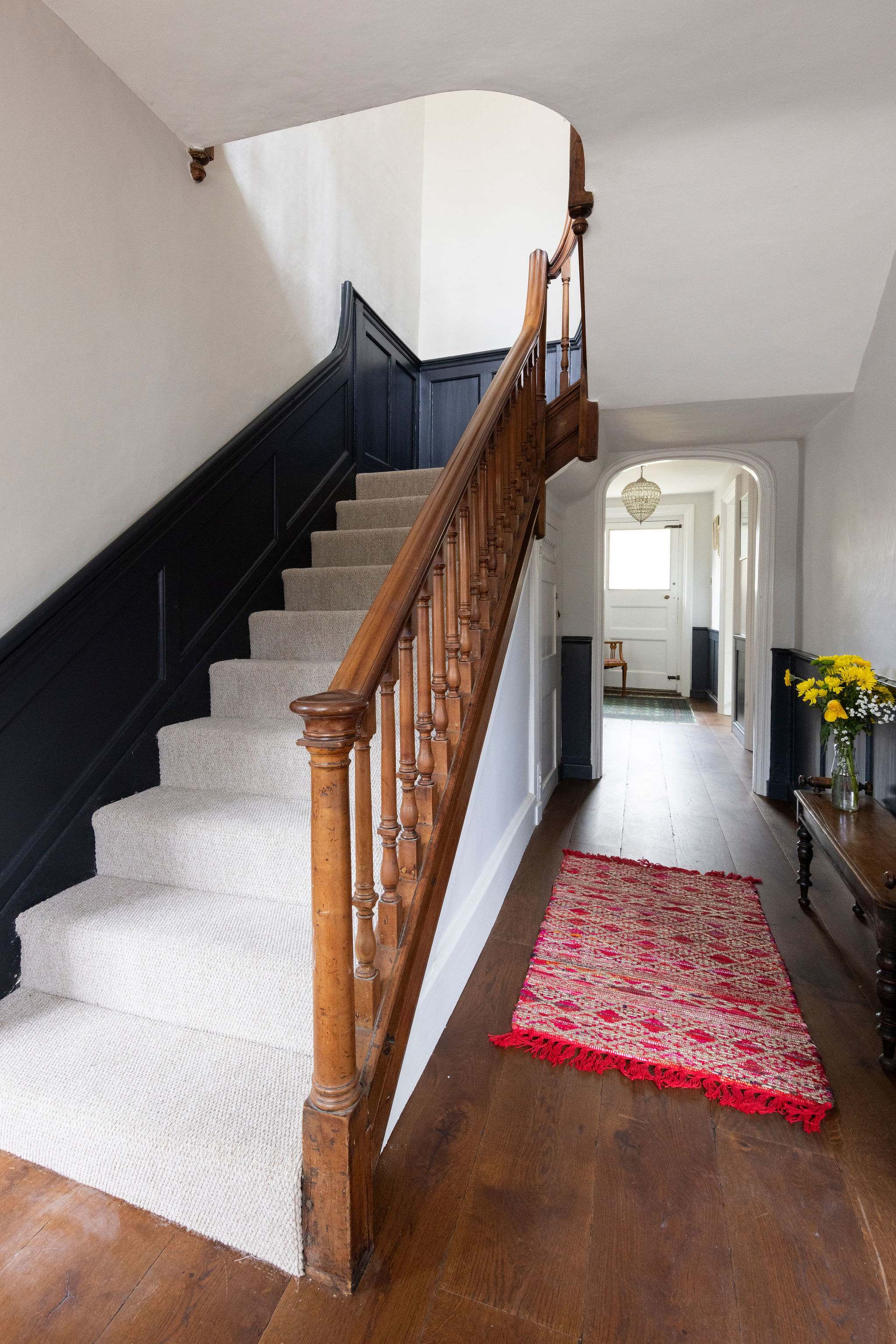 Stylish hallway with wooden banisters and timeless panelling