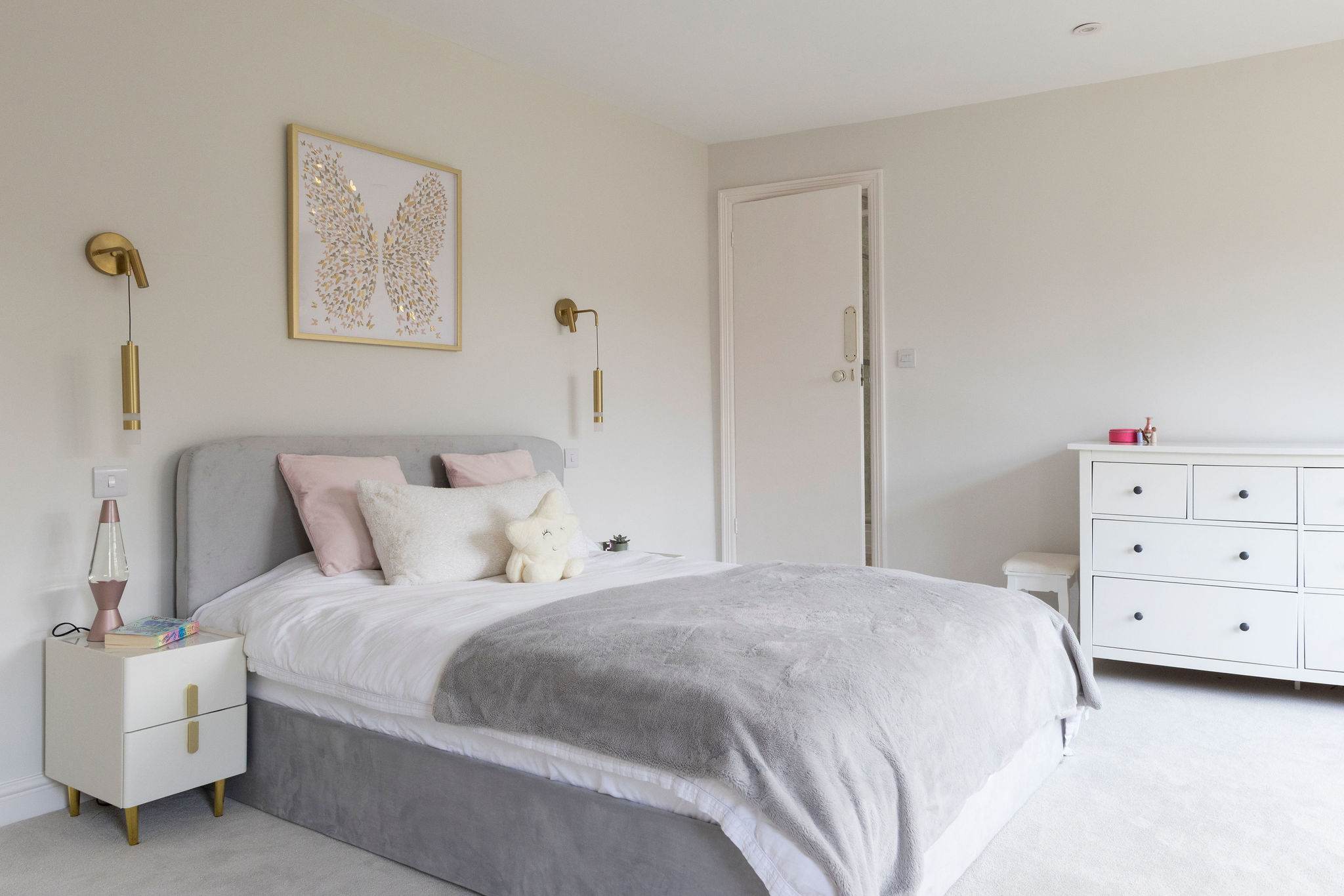 A chic bedroom with a plush bed and soft lighting