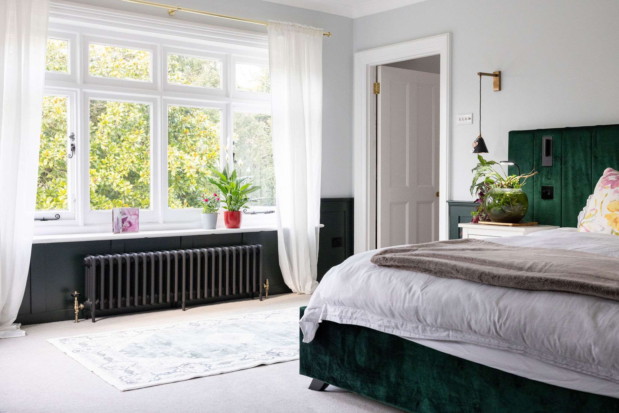 The grand master suite with a green velvet emporer bed and garden views