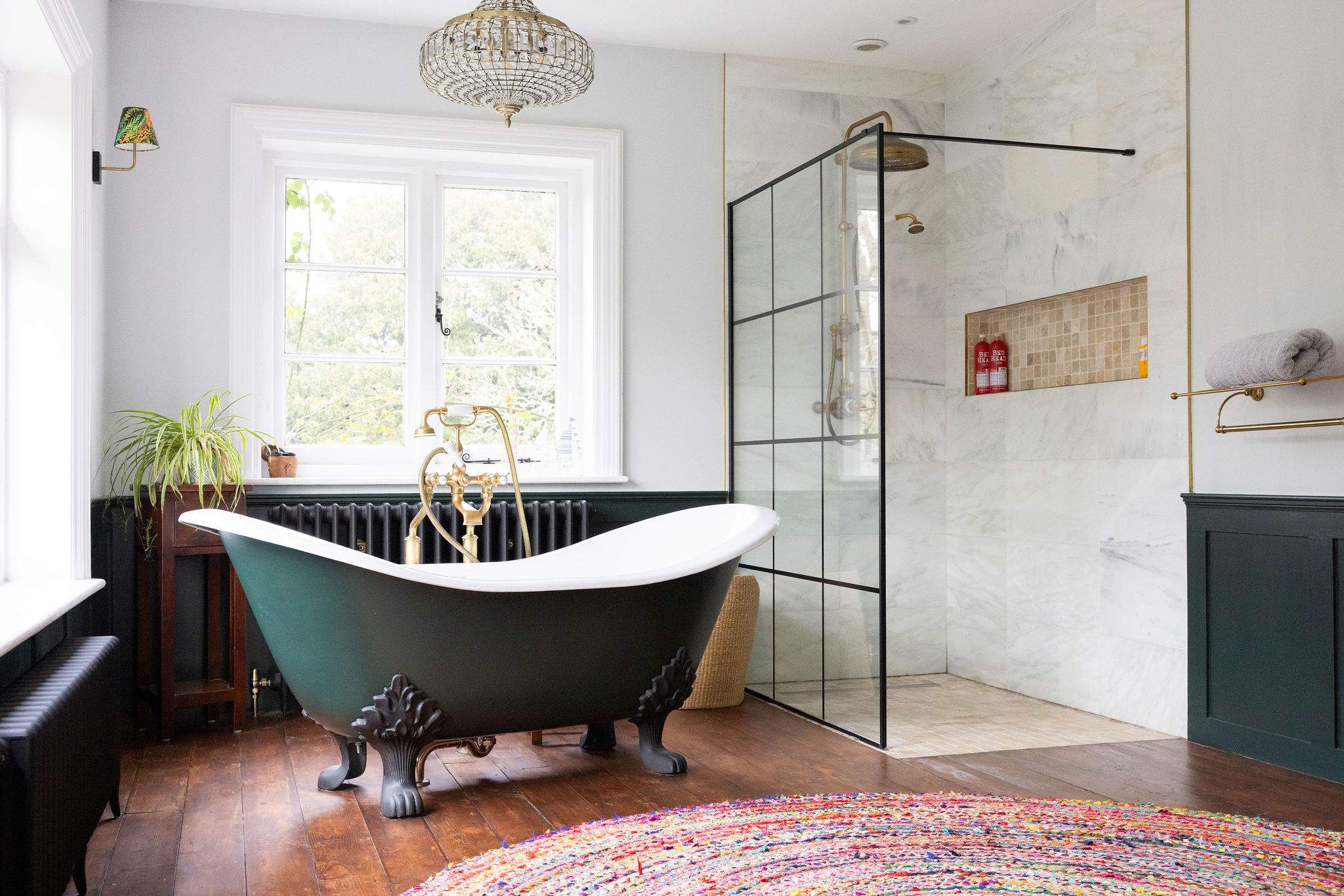 A spa-like en-suite with a roll-top bath and walk-in shower.