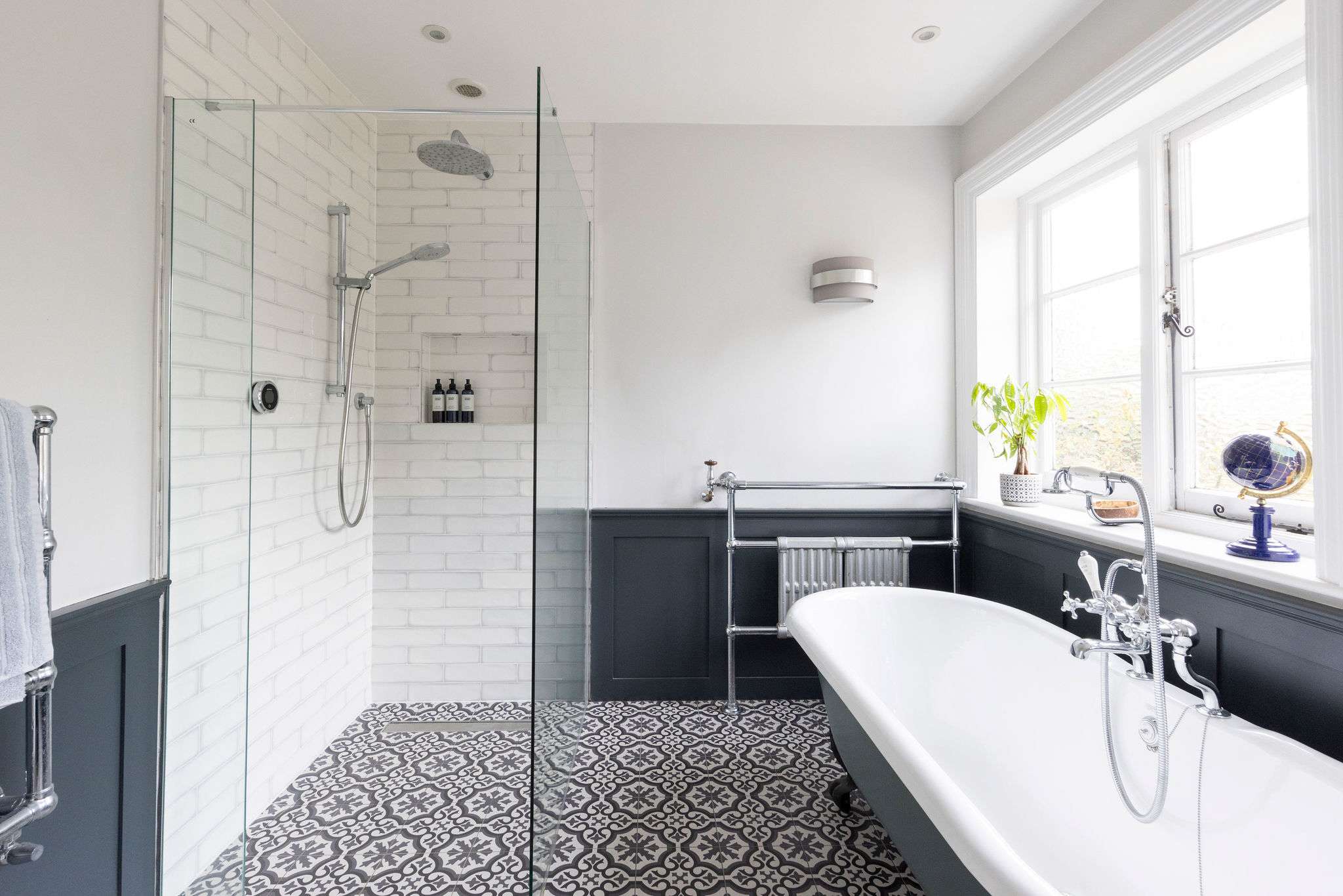 A sleek bathroom with a freestanding tub and walk-in shower