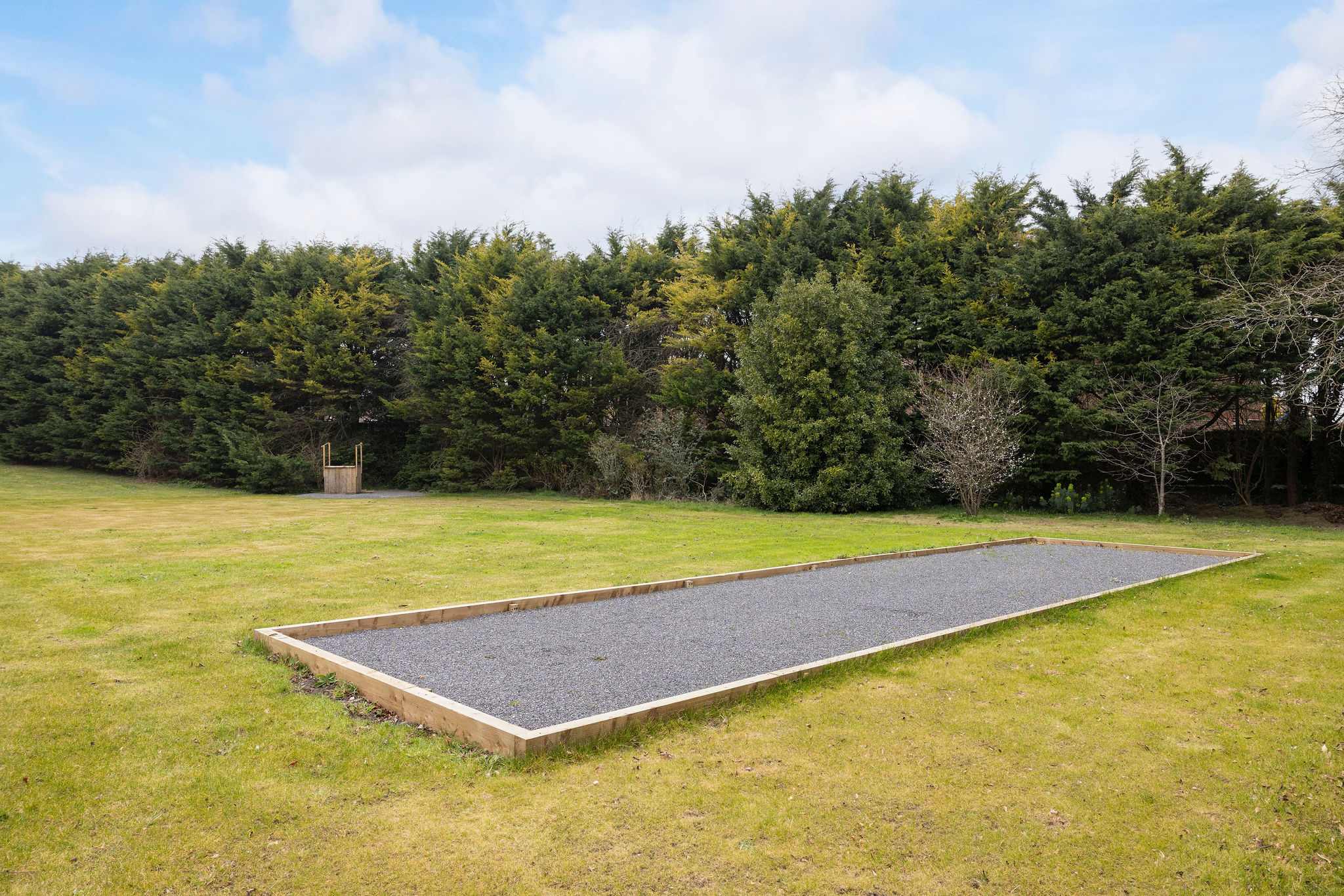 A newly built boules court set within a peaceful lawned area