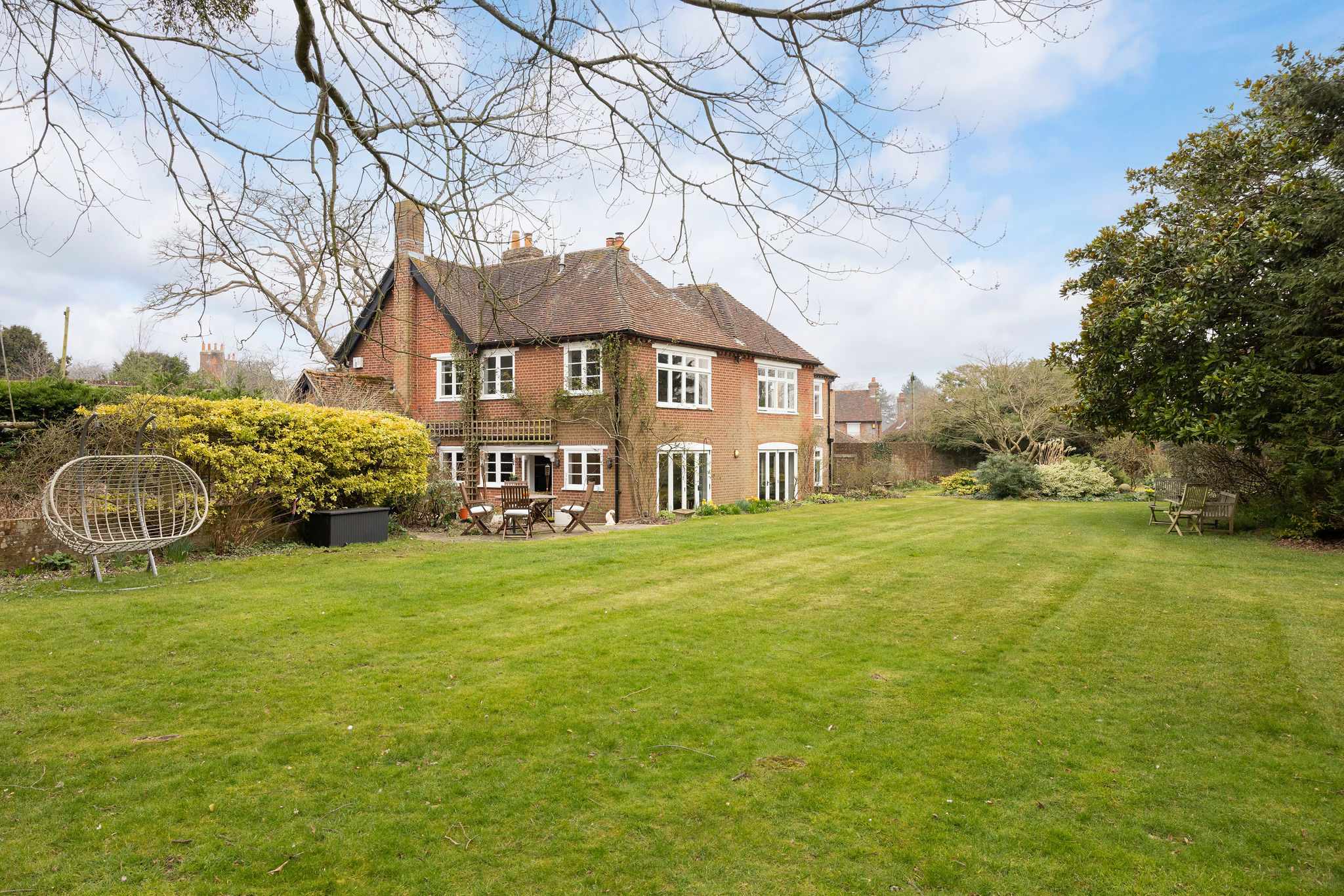 Expansive lawn and gardens surround this charming period home