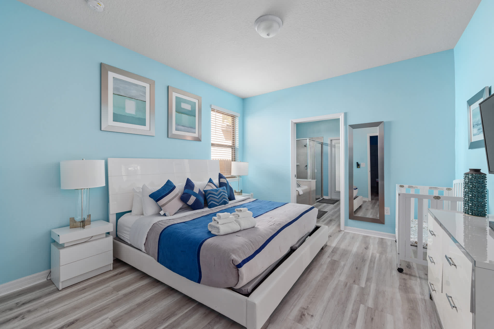 Primary bedroom downstairs, one king bed, one crib. En suite bedroom.