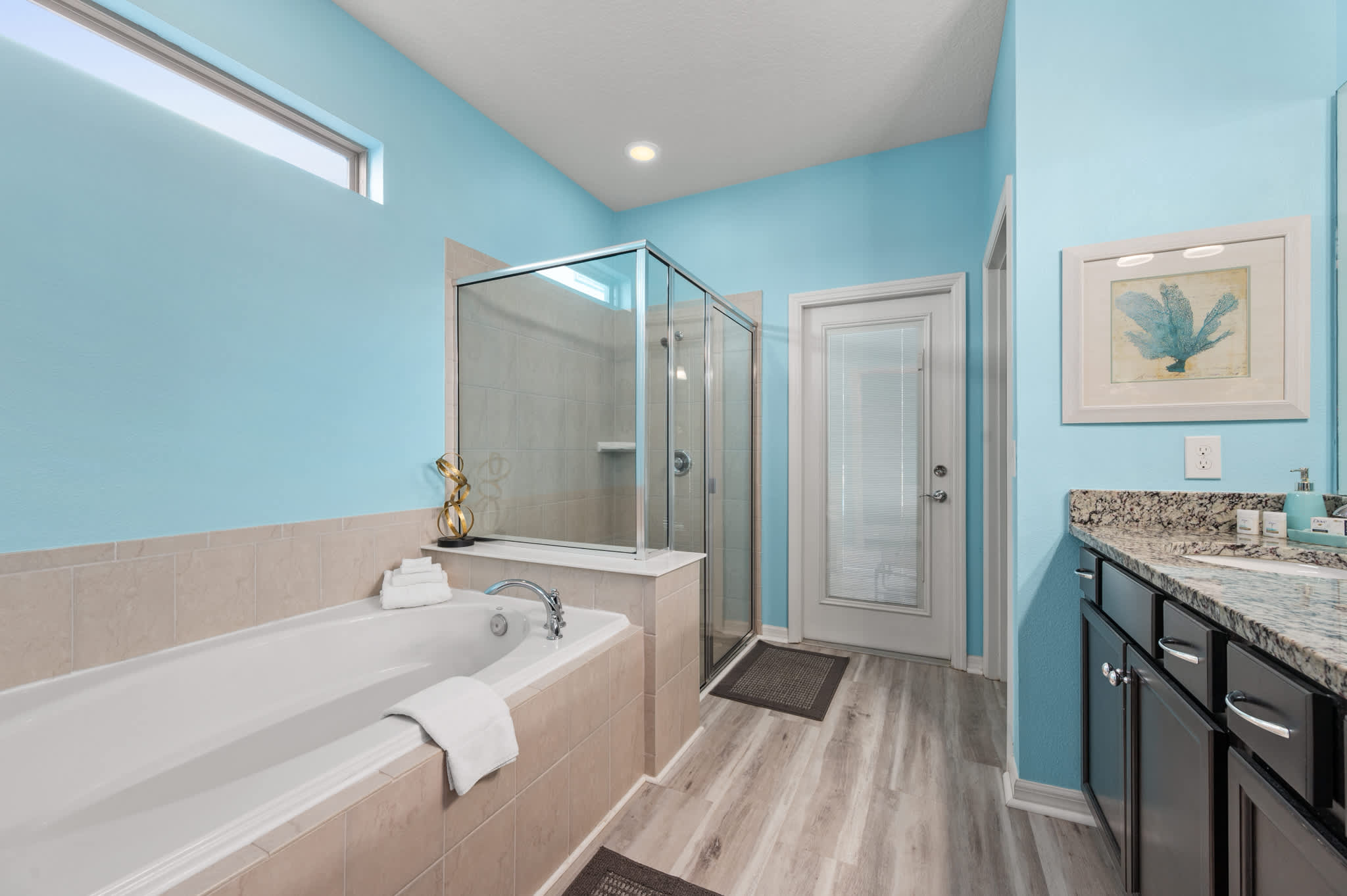 Primary downstairs bedroom with door to exterior (pool area)