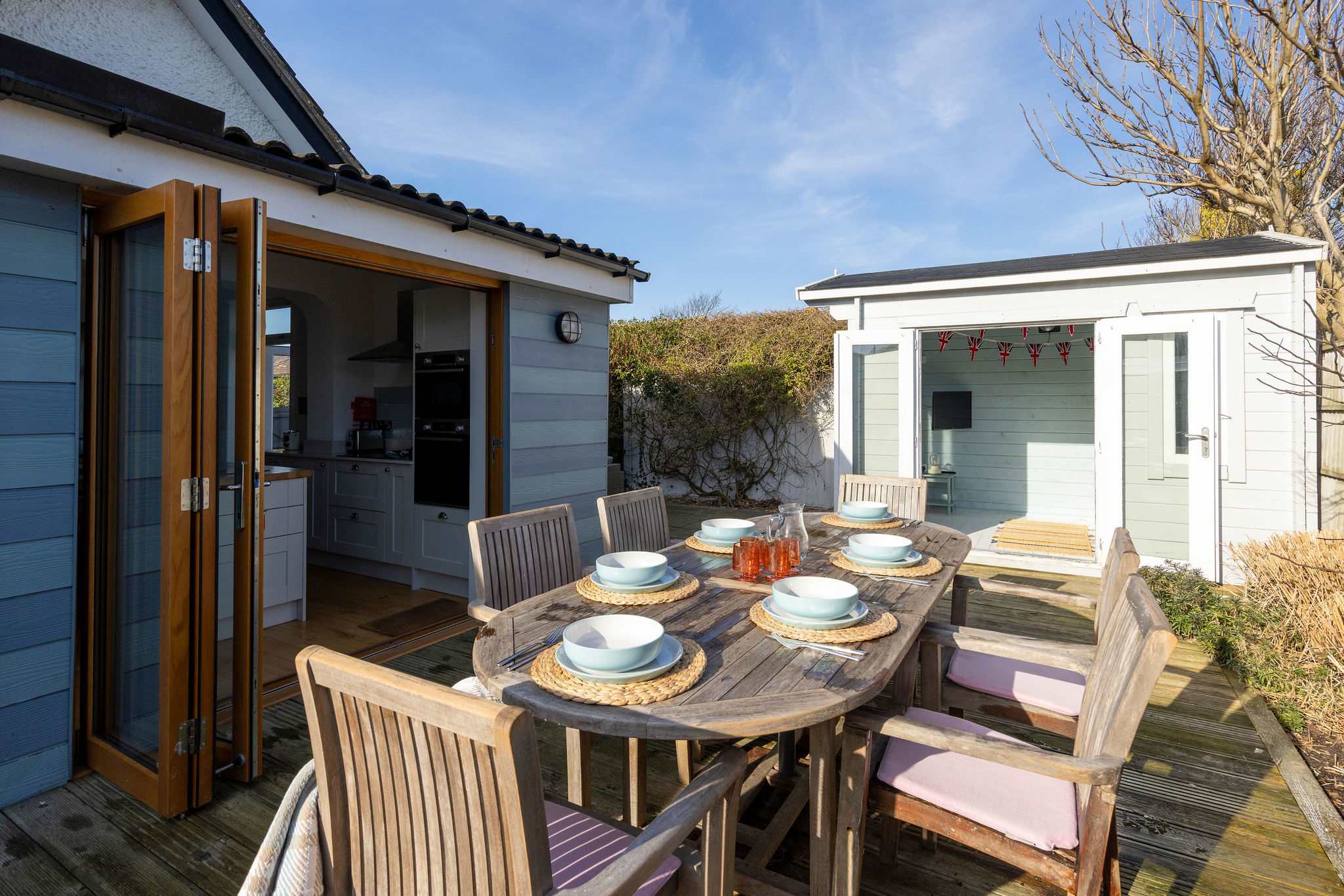 Enjoy outdoor dining on the sunny deck with seating for six, perfect for family meals. This charming cottage offers a wonderful space for relaxation and making memories.