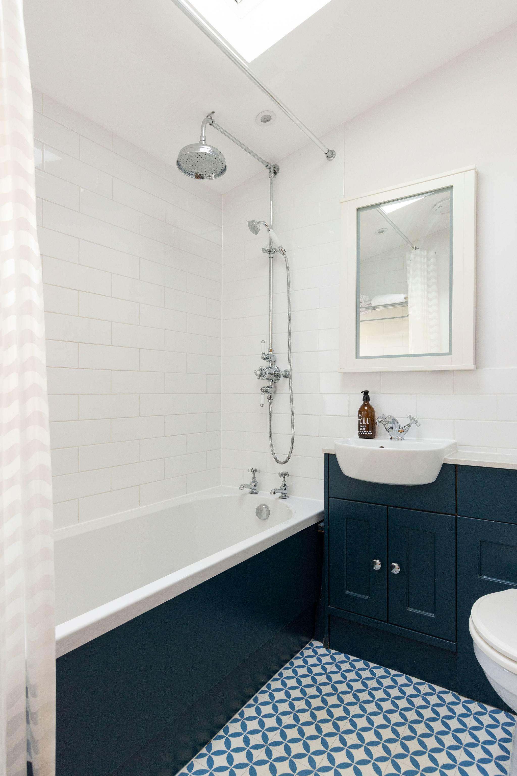 The family bathroom features a bath with an overhead shower.