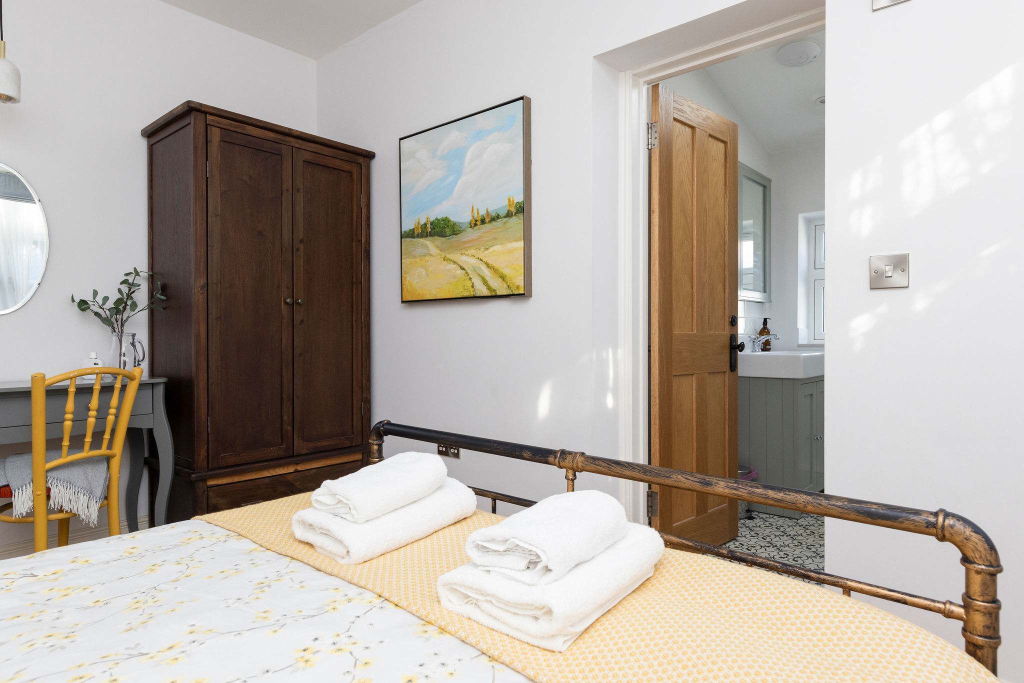 Ample storage with a wardrobe and desk, perfect for a relaxing seaside getaway. Enjoy the convenience of an en-suite bathroom just through the doorway.