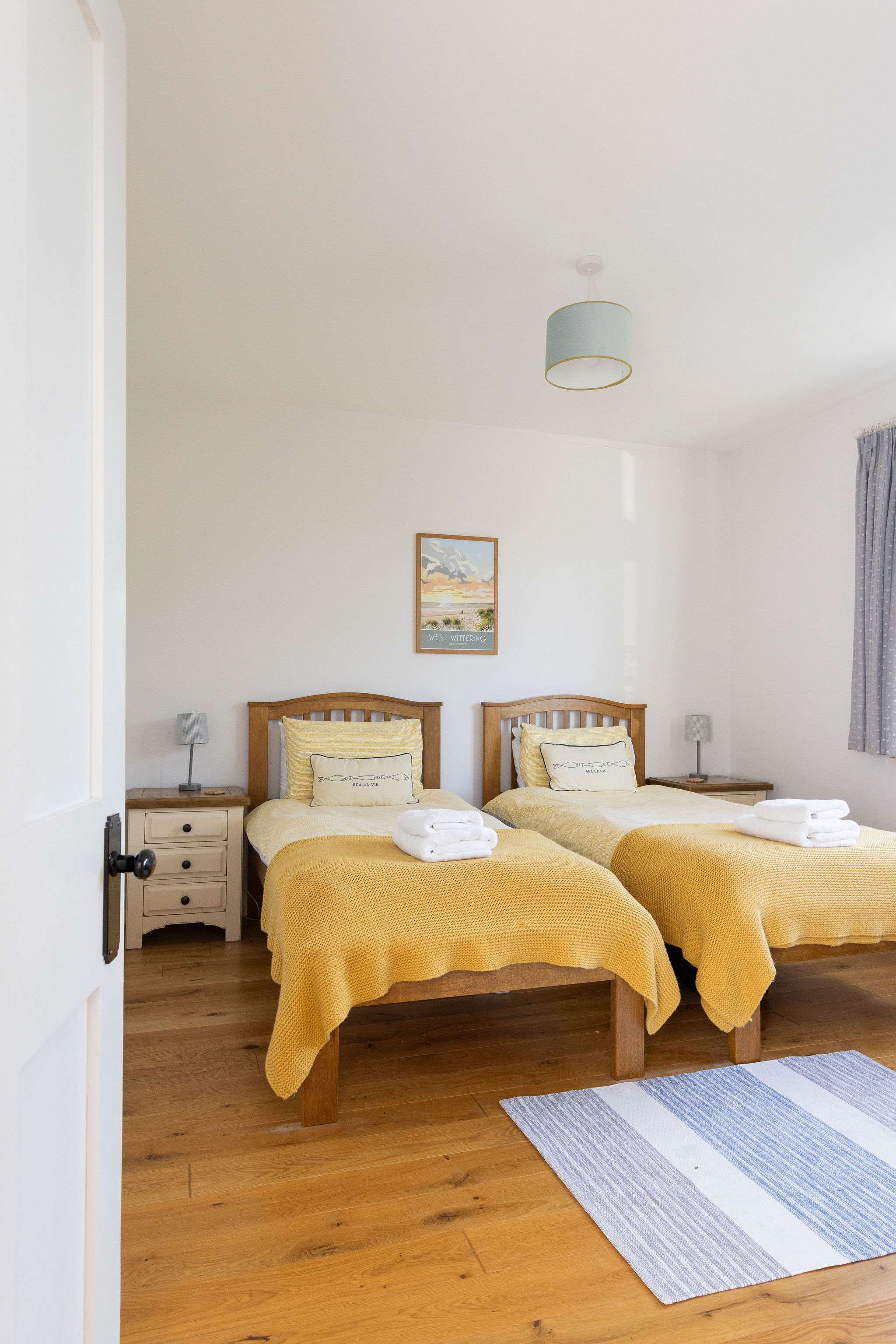 Bedroom 3 This twin bedroom offers comfortable sleeping arrangements with warm yellow accents and ample natural light. Perfect for friends or family traveling together.