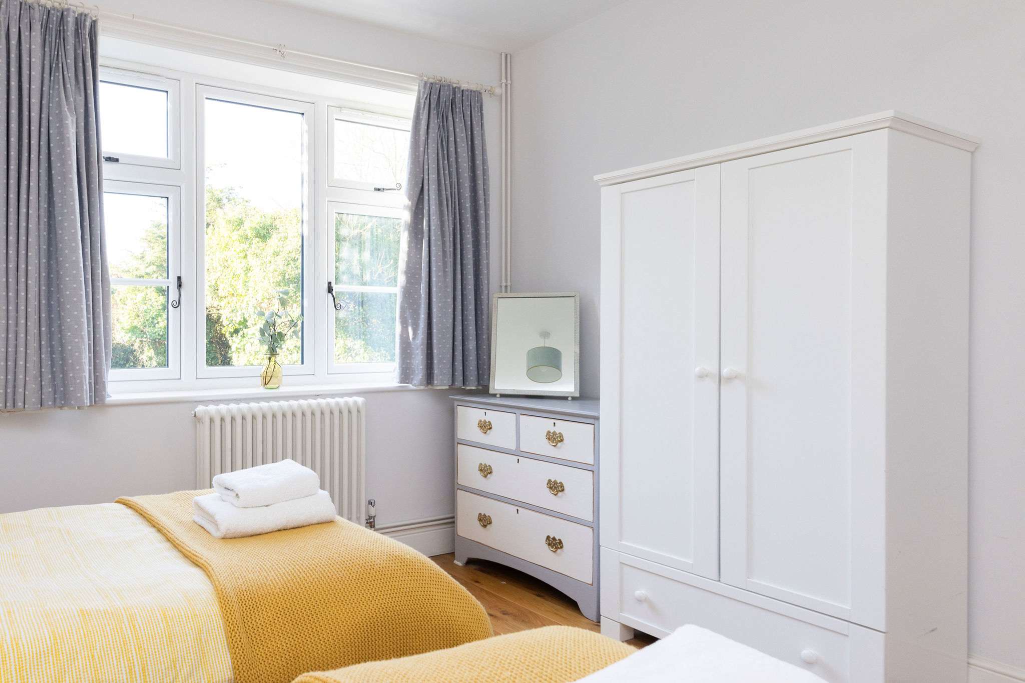 This twin bedroom has wardrobes and chest of drawers for your personal belongings.