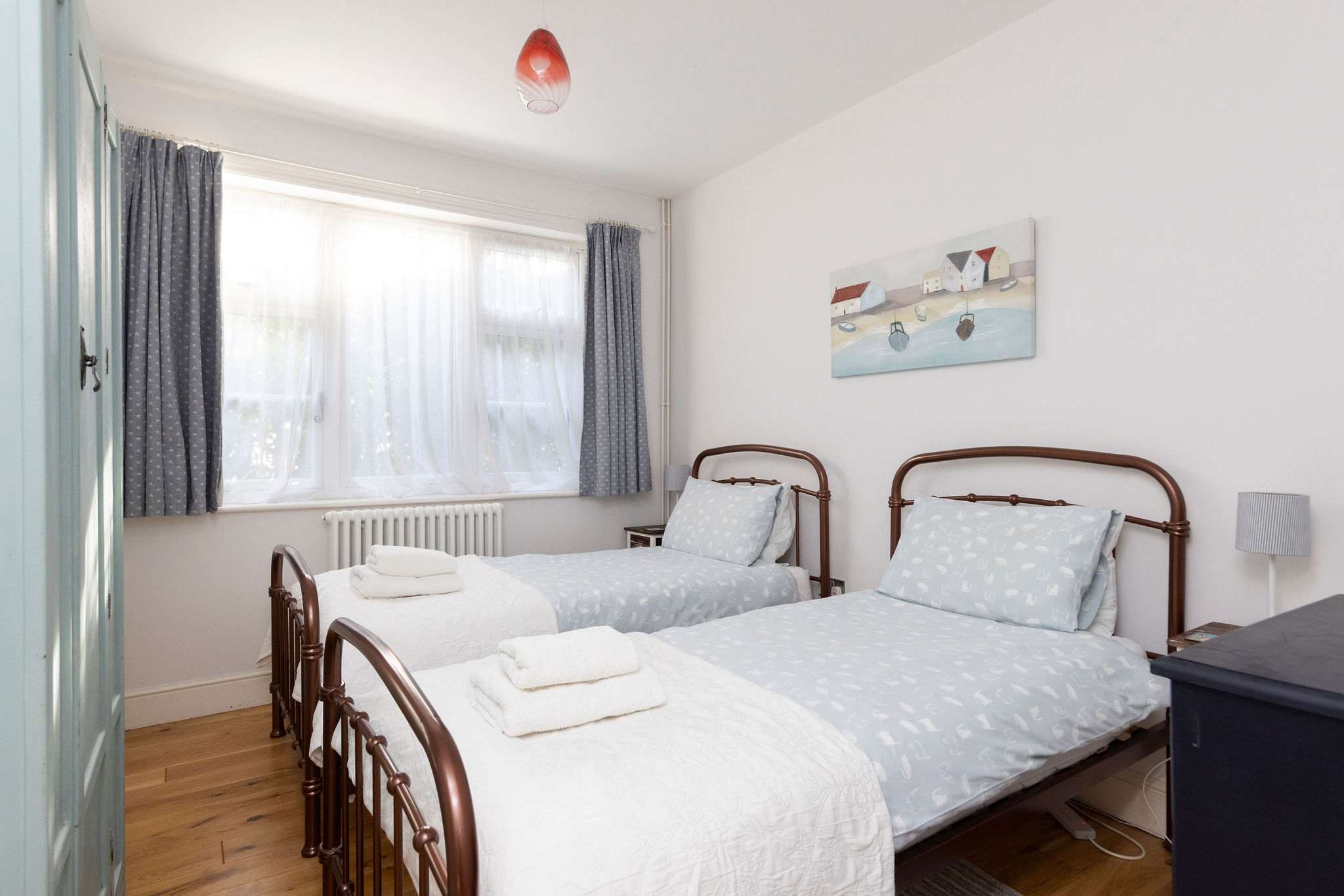 Bedroom 2 This inviting twin bedroom is thoughtfully furnished with comfortable beds and ample storage for a relaxing stay. Ready to unwind in this comfortable space after a day of coastal adventures?