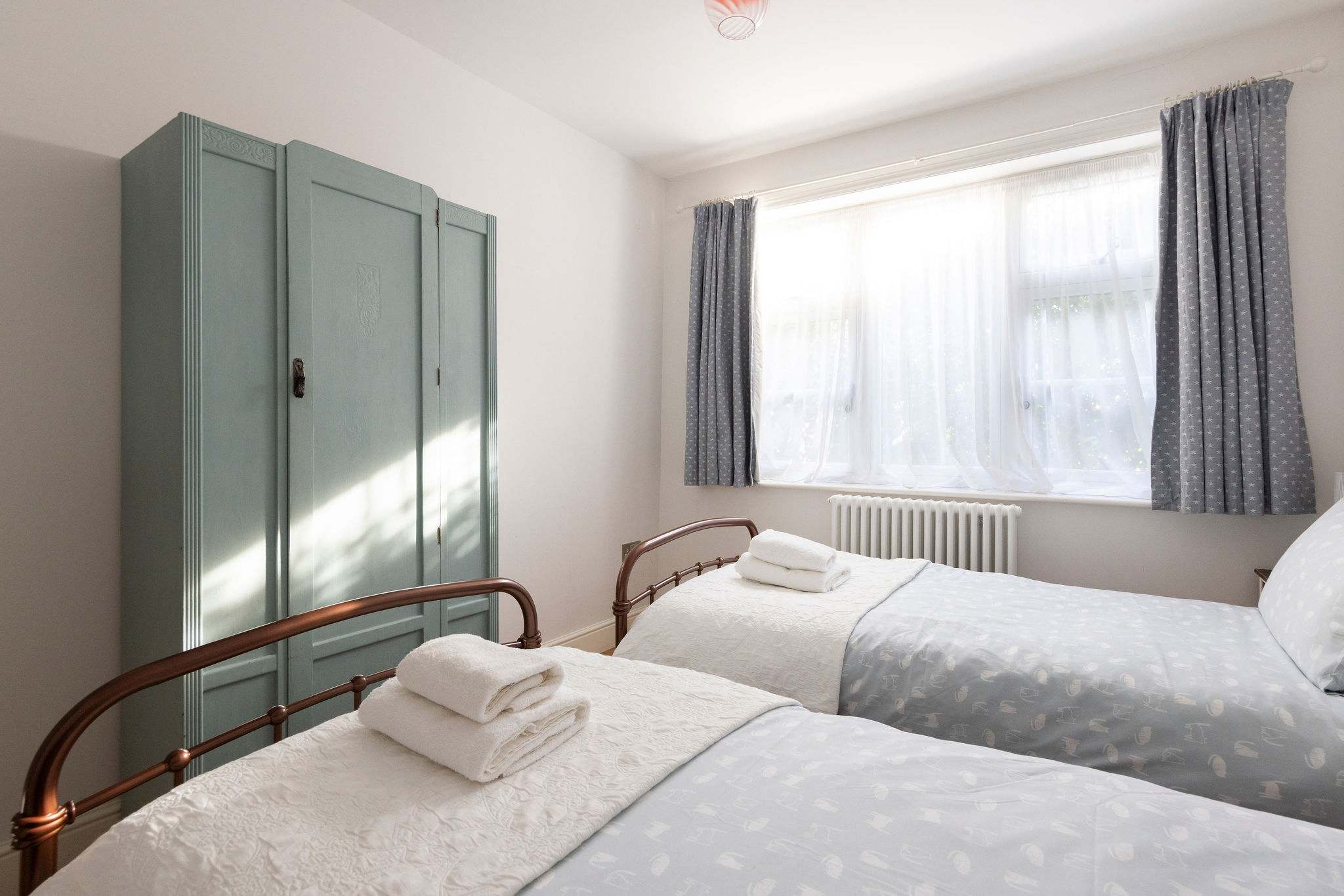 Lovely twin bedroom with wardrobe.