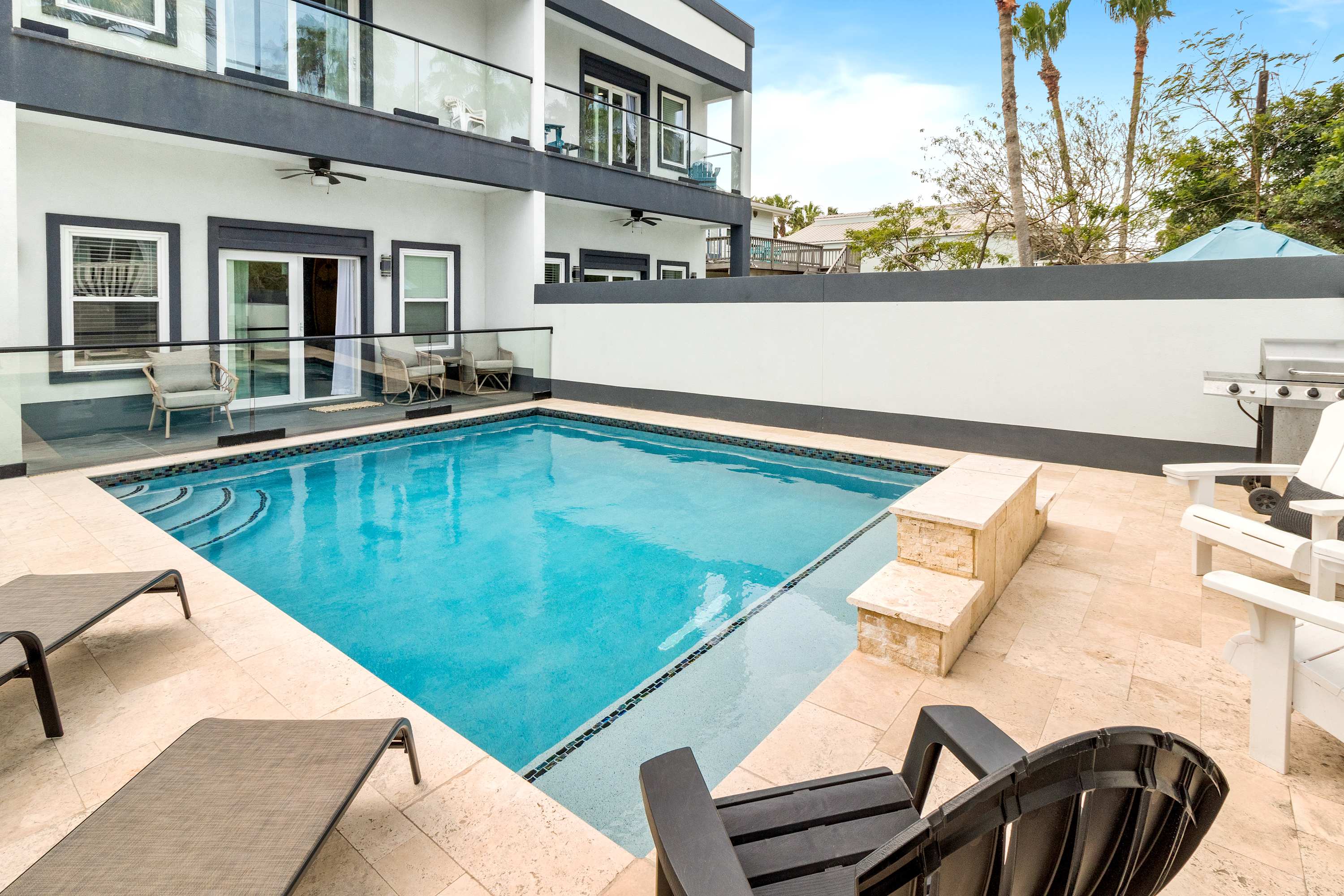 Outdoor swimming pool with sun loungers