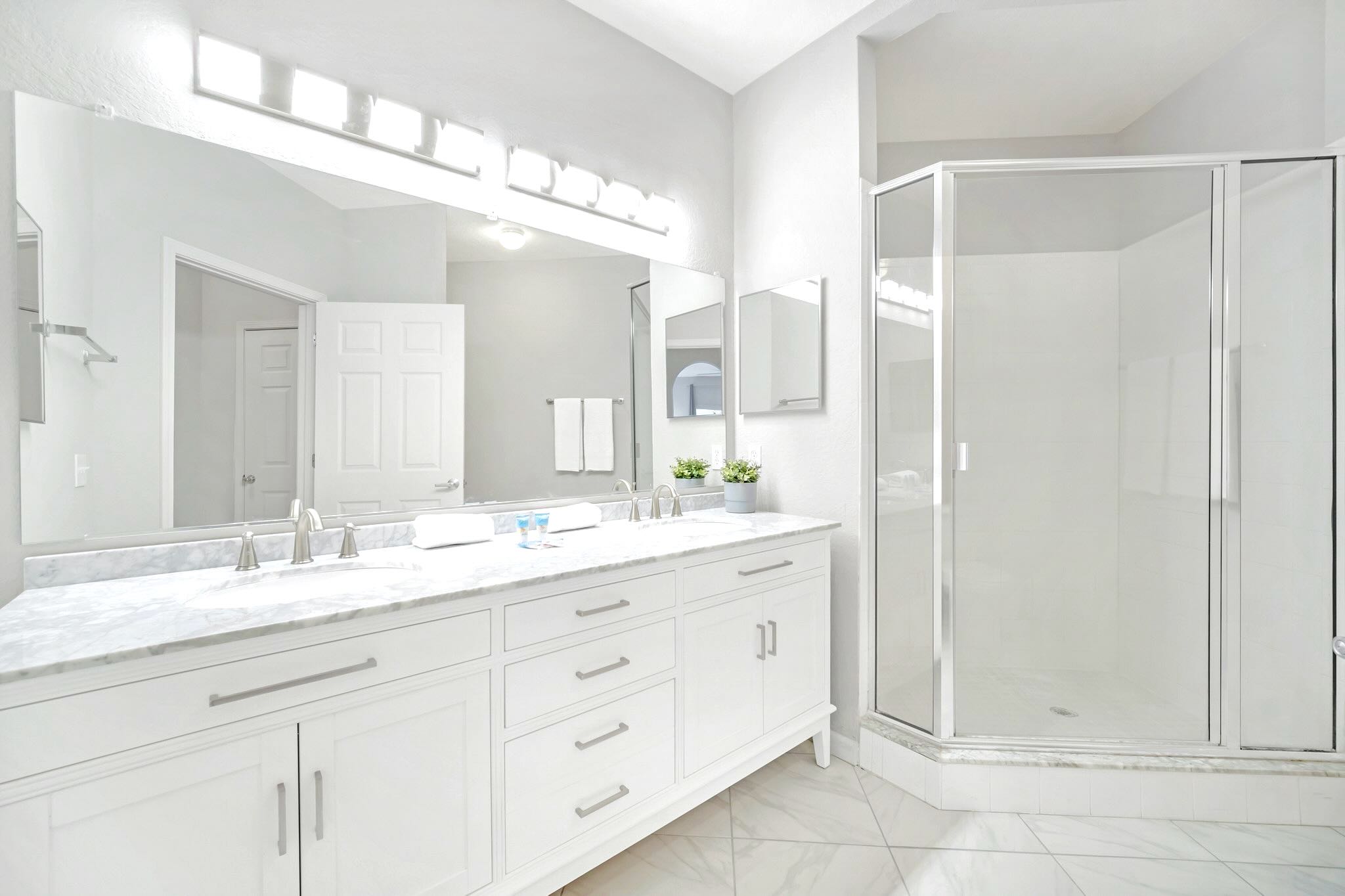 Full bathroom with double vanity and standing shower 