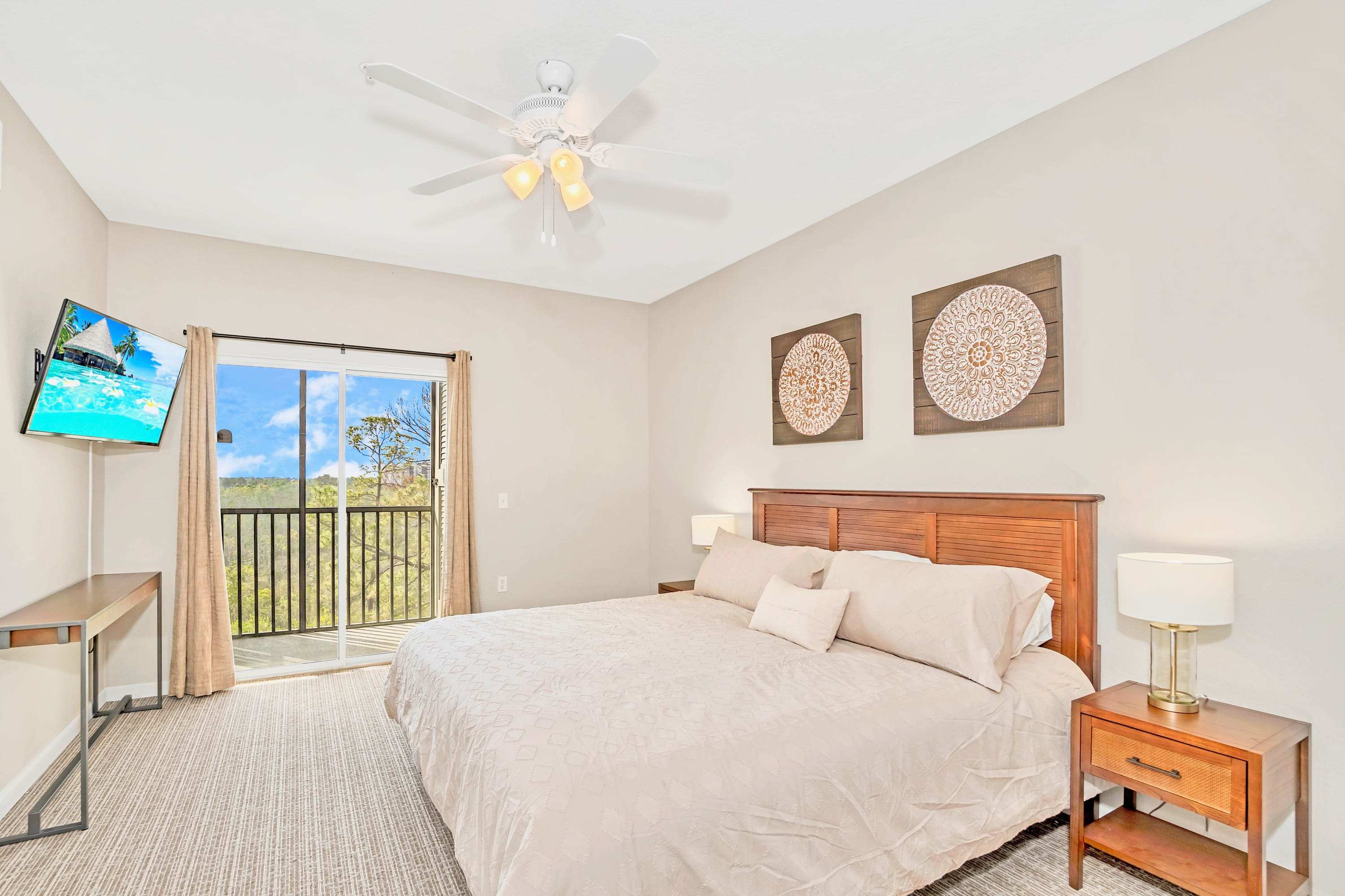 King bedroom with smart TV and patio access