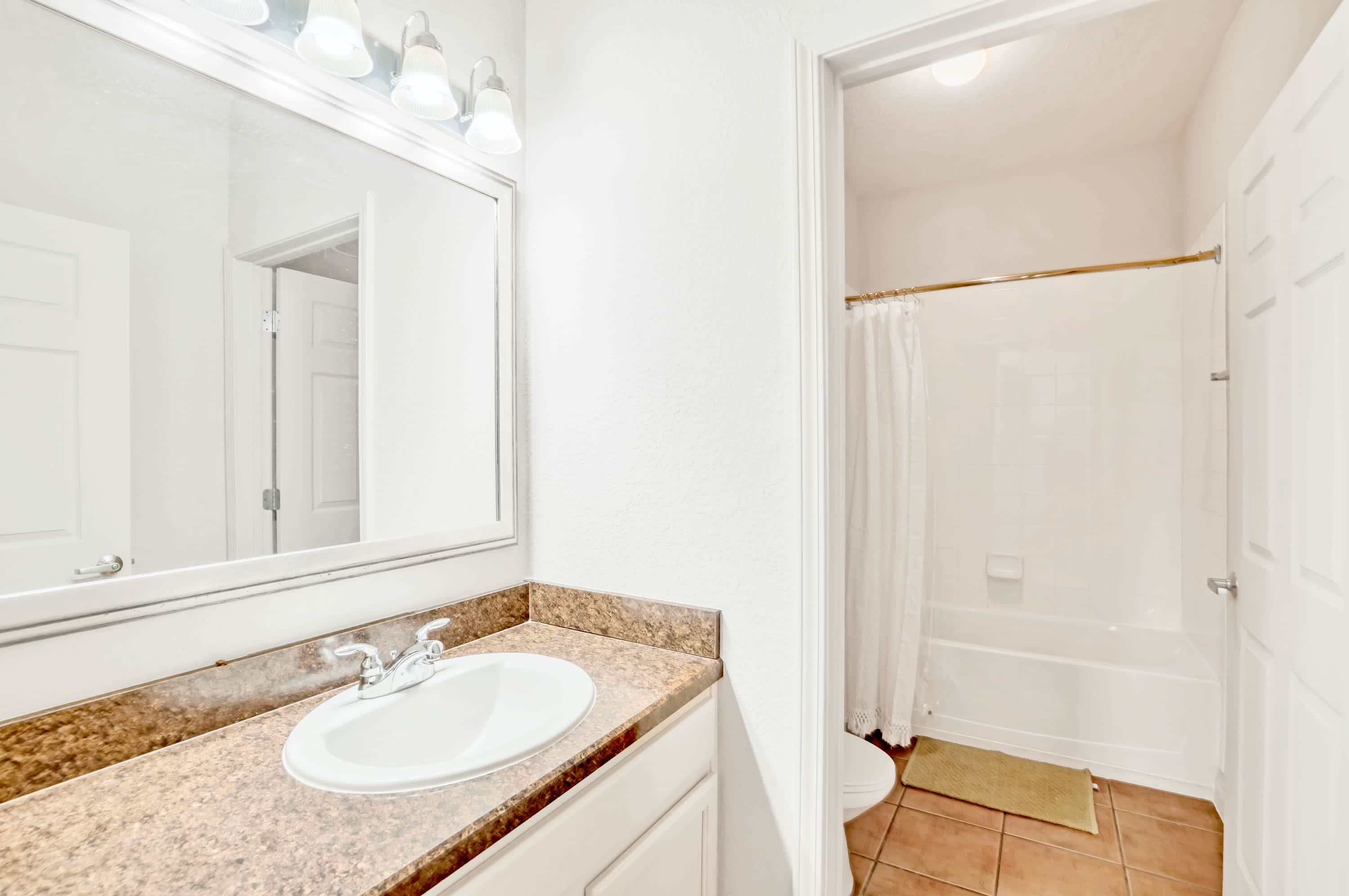 Full bathroom with combined shower and bathtub