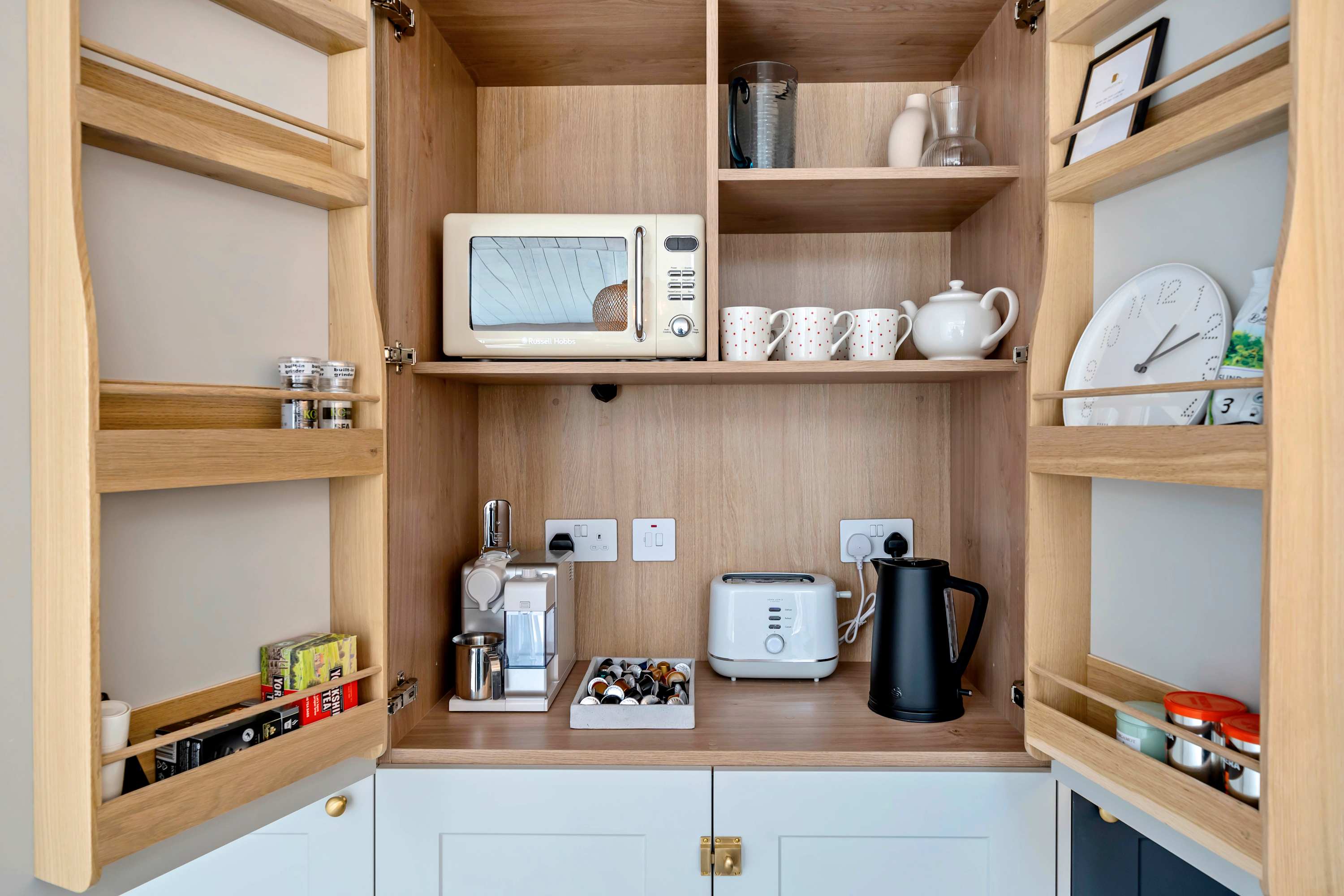 Pantry nook with all your essentials - microwave, toaster, kettle, coffee, and tea, perfect for easy mornings or late-night snacks.
