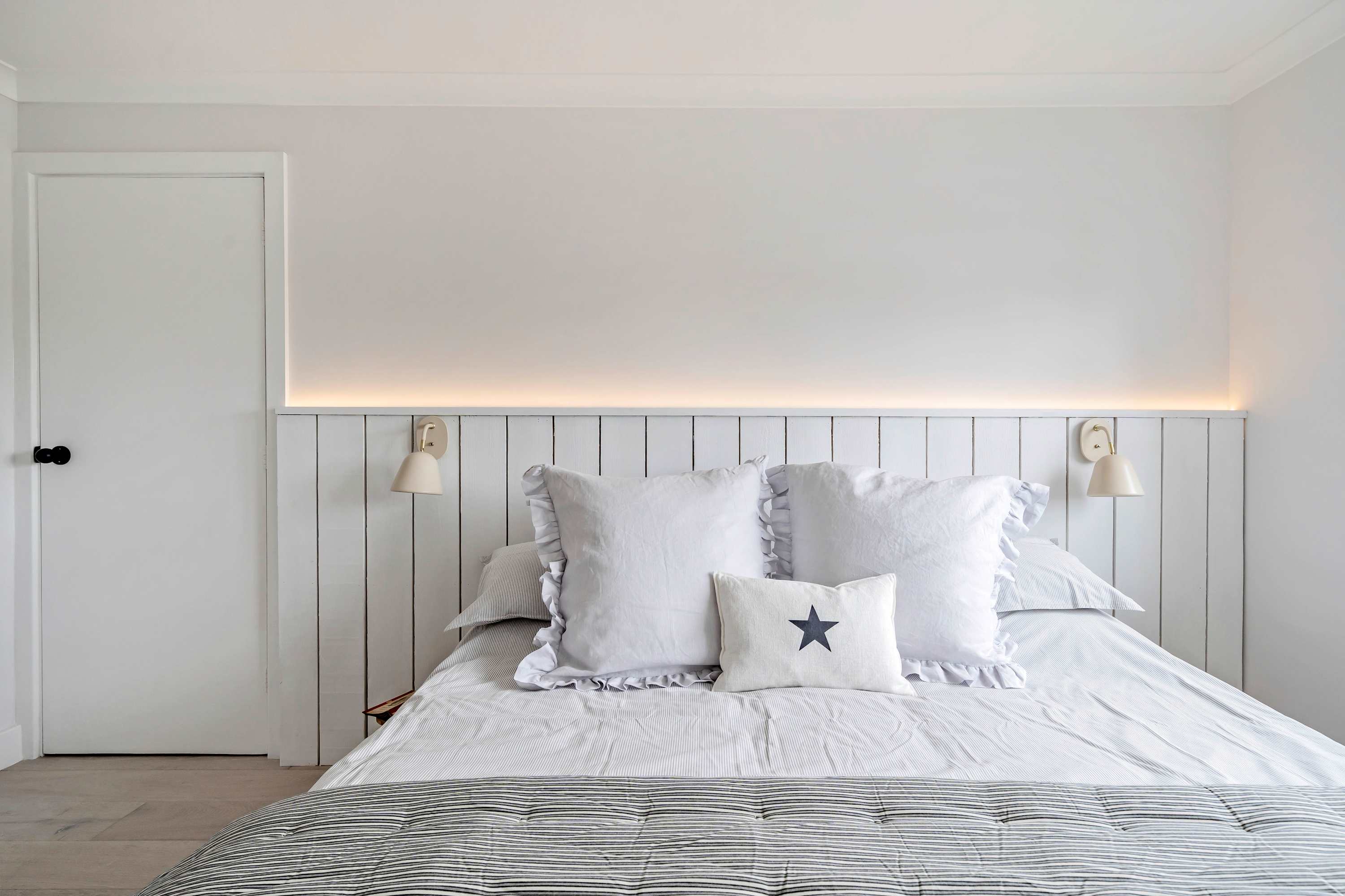 Drift off to dreamland in the king bedroom. Fresh linen and soft lighting create a tranquil ambiance for a great night's sleep.