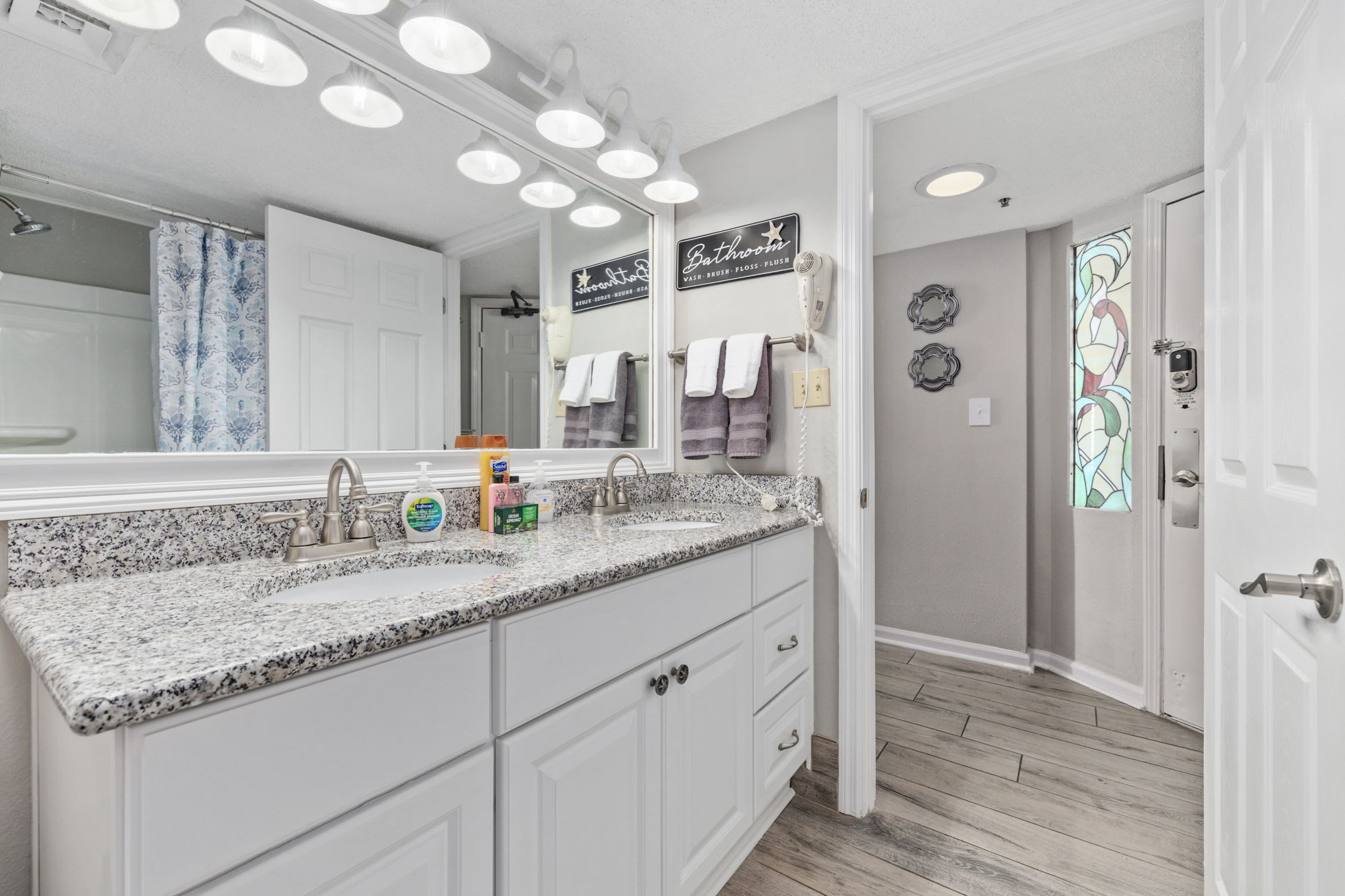 Rinse off in this clean, bright bathroom with fluffy towels and coastal vibes.