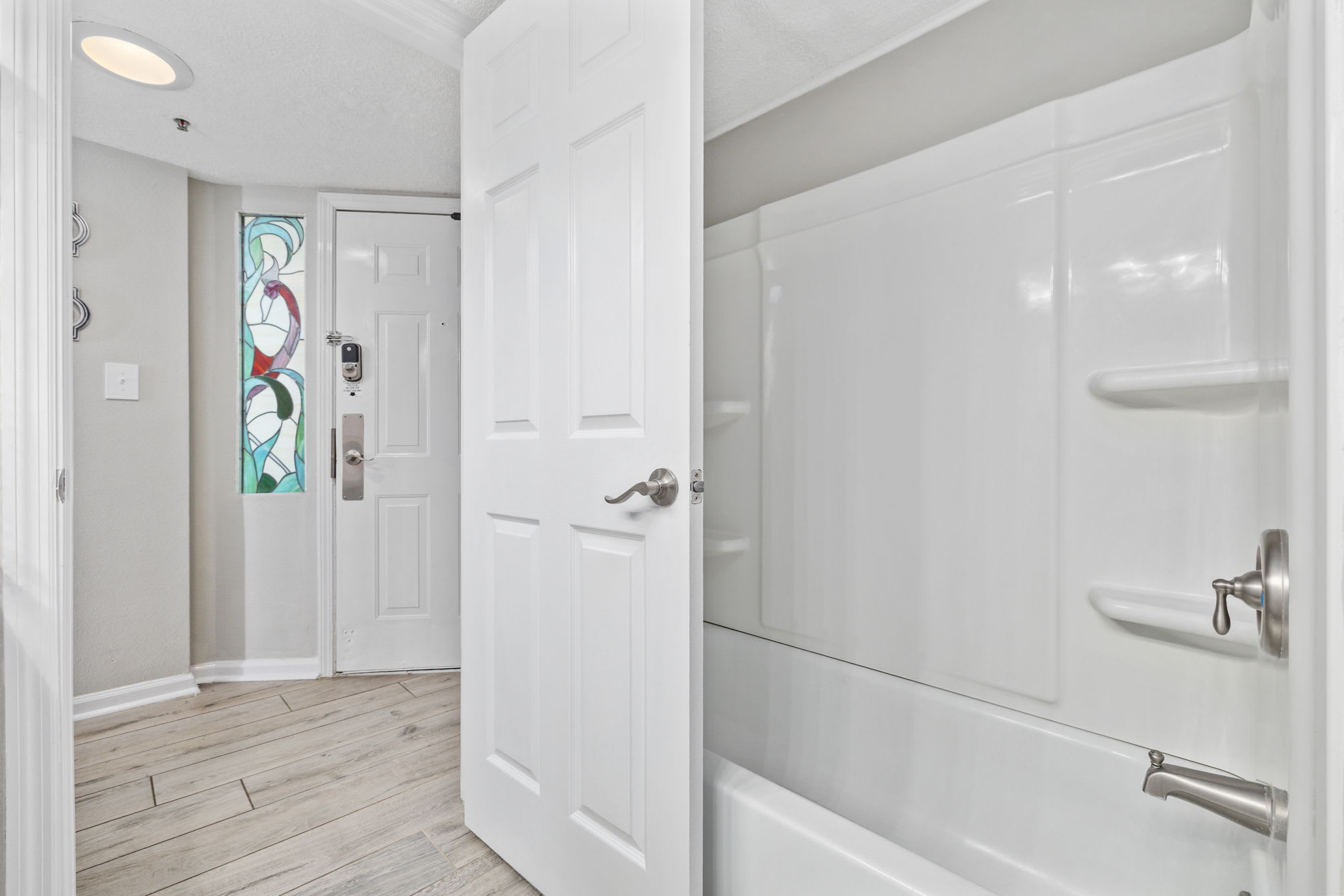 Rinse off in this clean, bright bathroom with fluffy towels and coastal vibes.