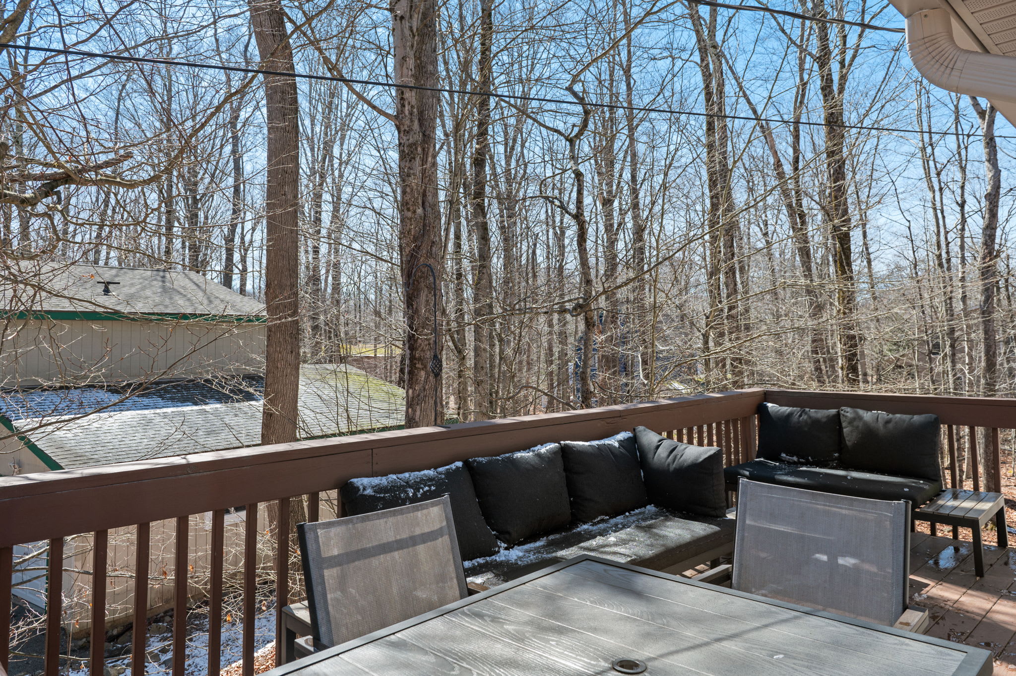 Enjoy your morning coffee on the spacious deck overlooking the woods.