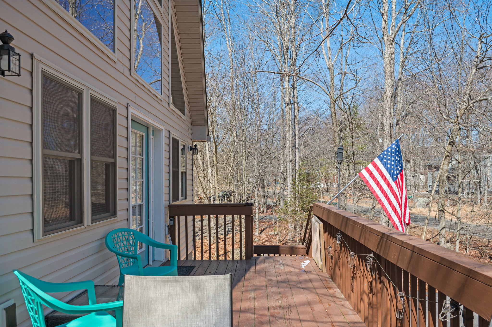 Pull up a colorful chair and take in the peaceful forest views from the deck.