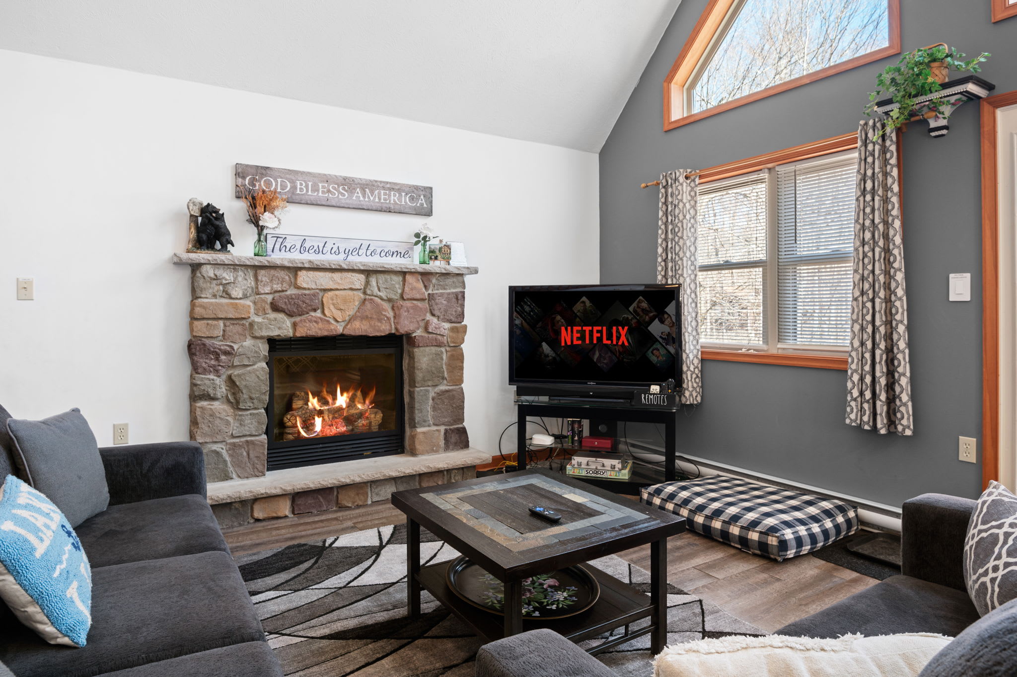 Cozy up by the beautiful stone fireplace in the inviting living room