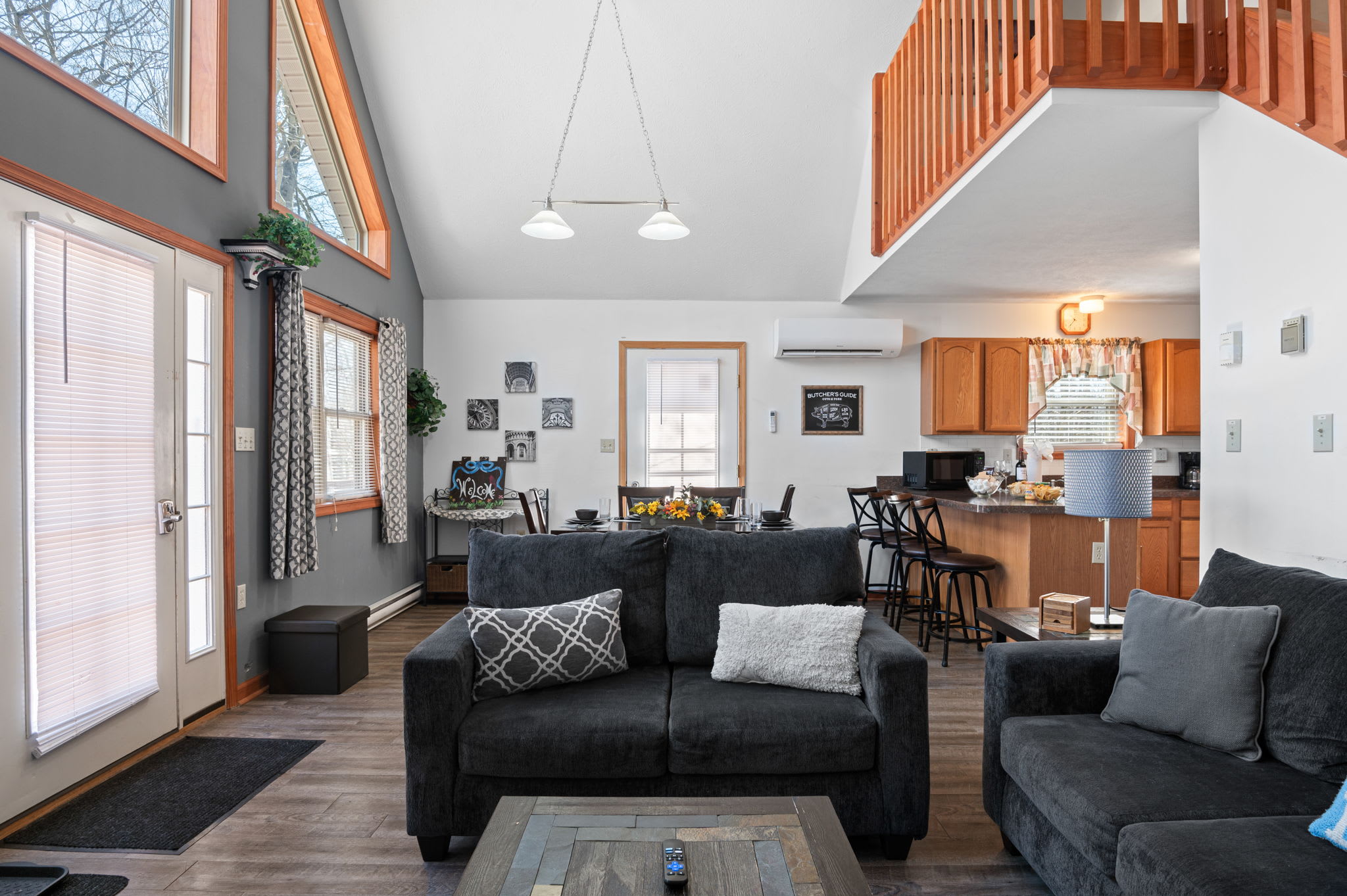 Relax in the open-concept living space with a large sectional sofa and mountain views