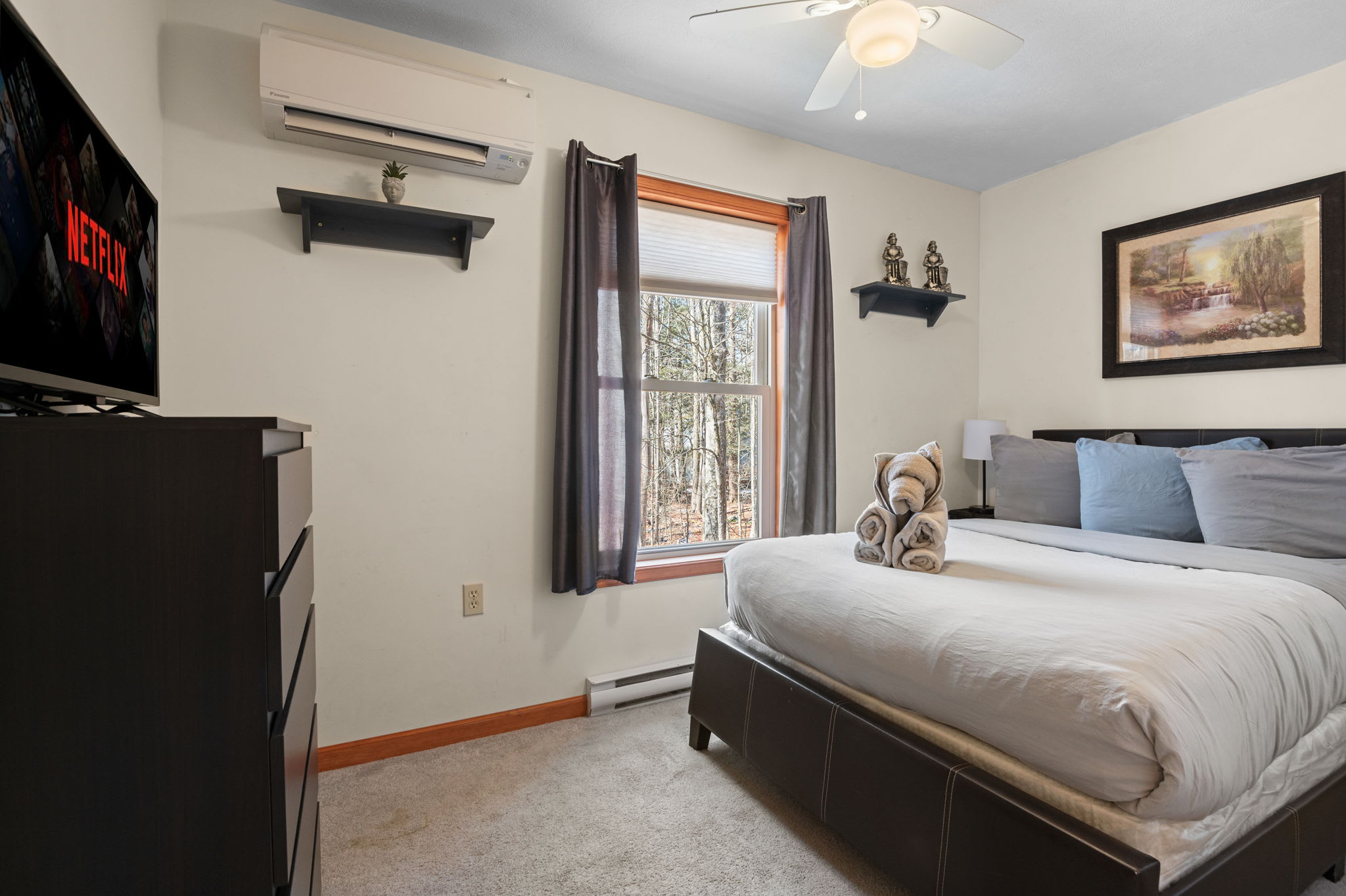 Rest easy in this cozy queen bedroom with rustic wood accents and soft natural light