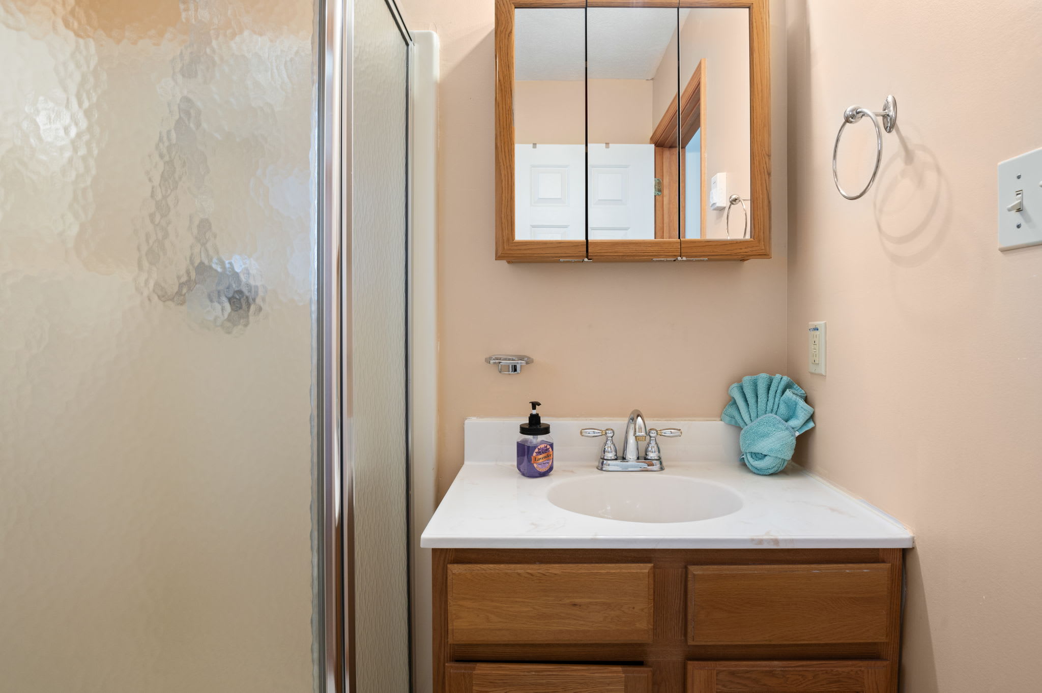 The stylish bathroom vanity features coastal decor and convenient storage space