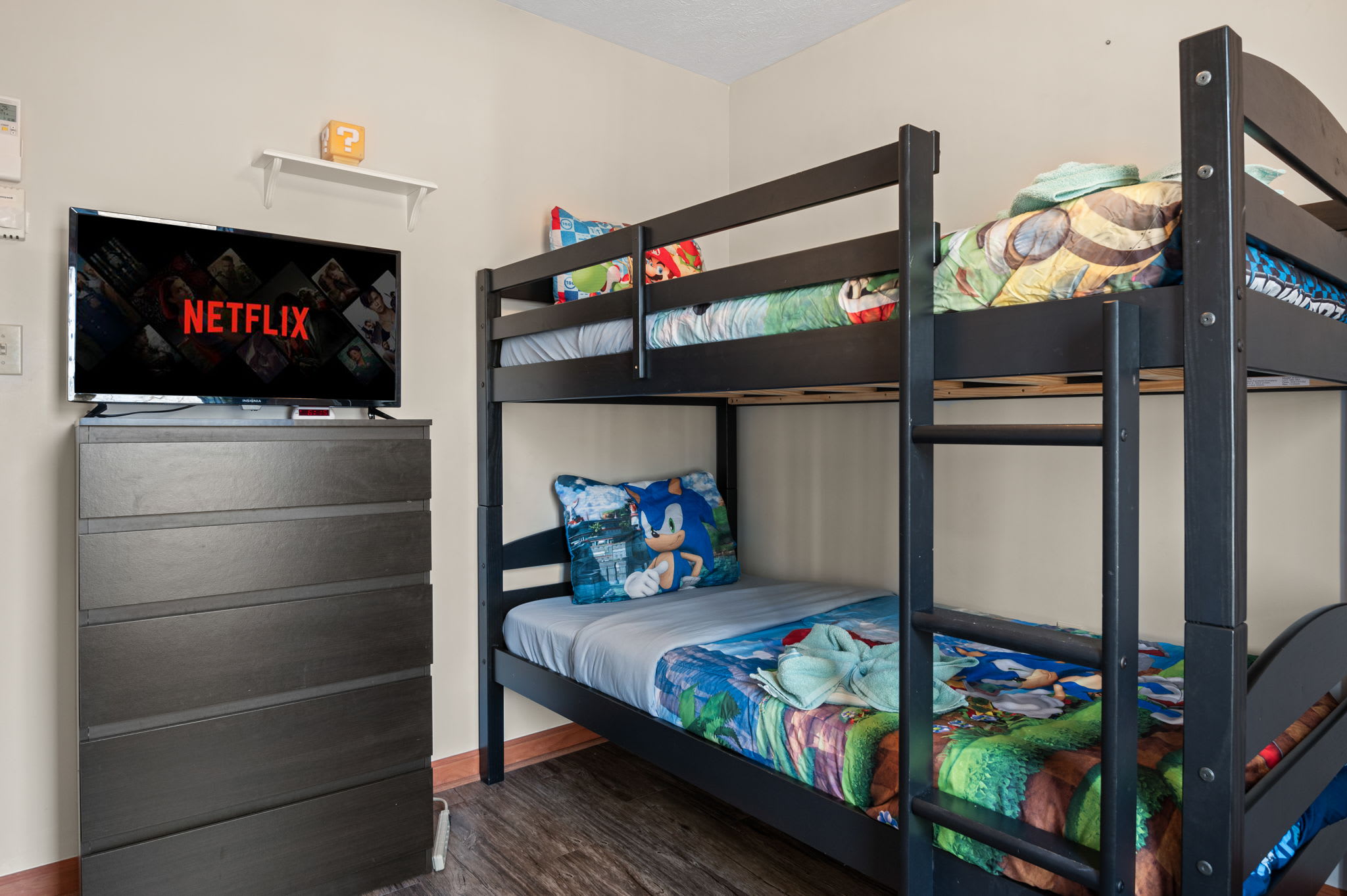 The bunk room is a kids' dream with colorful bedding and a cozy corner for movie nights