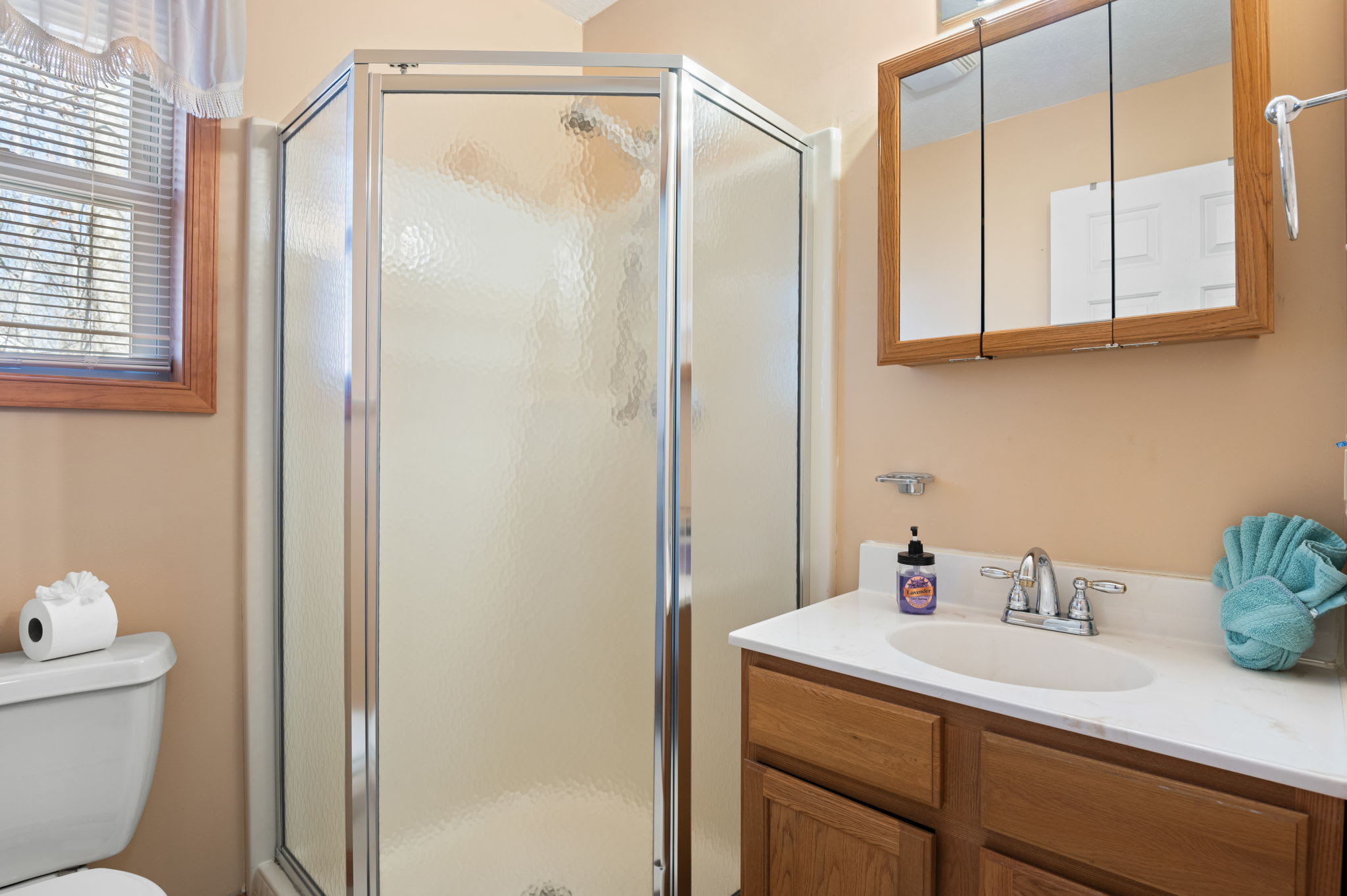 Freshen up in the clean full bathroom with modern vanity and walk-in shower