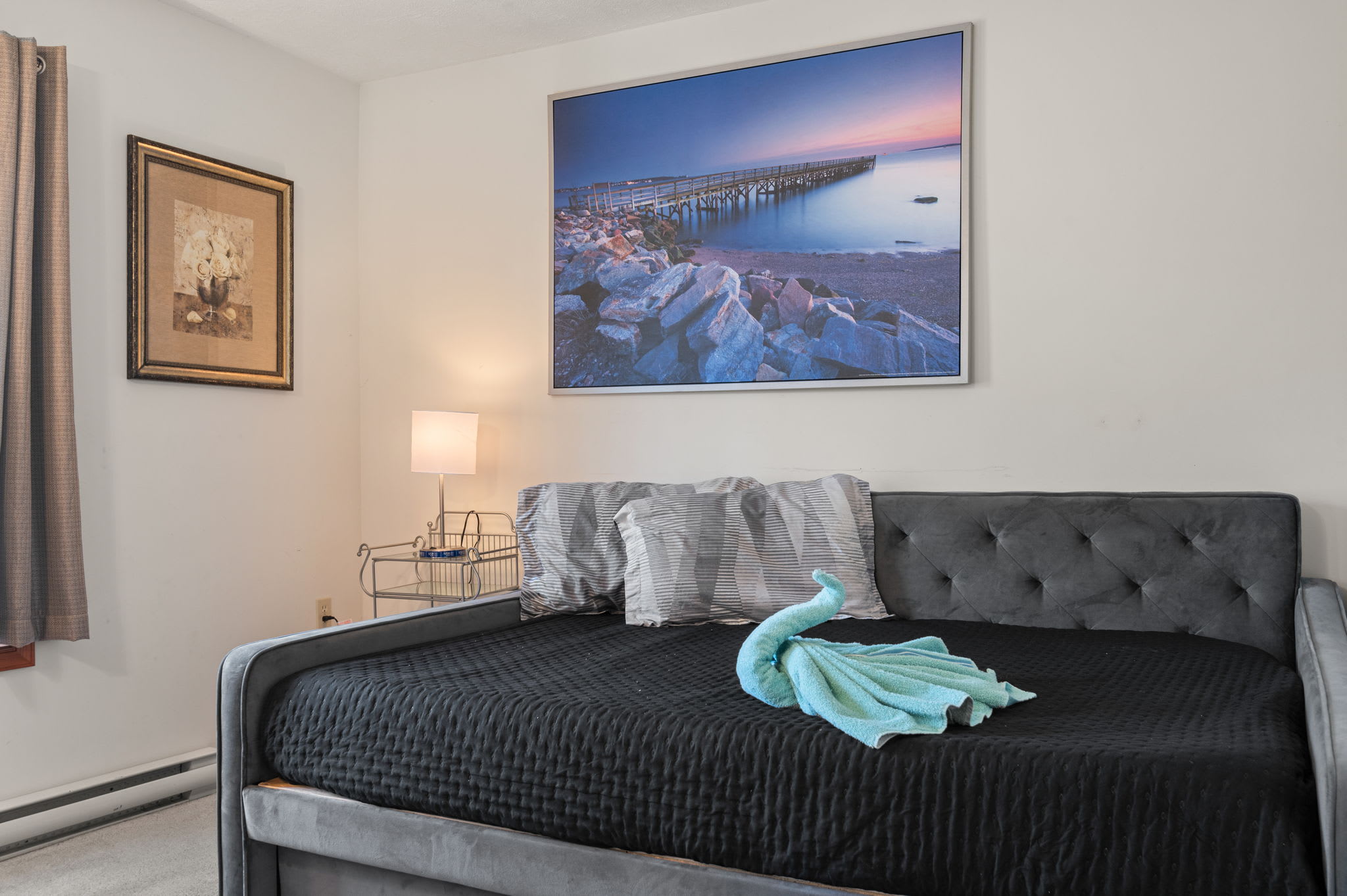 Art and ambient lighting create a warm and inviting master bedroom atmosphere